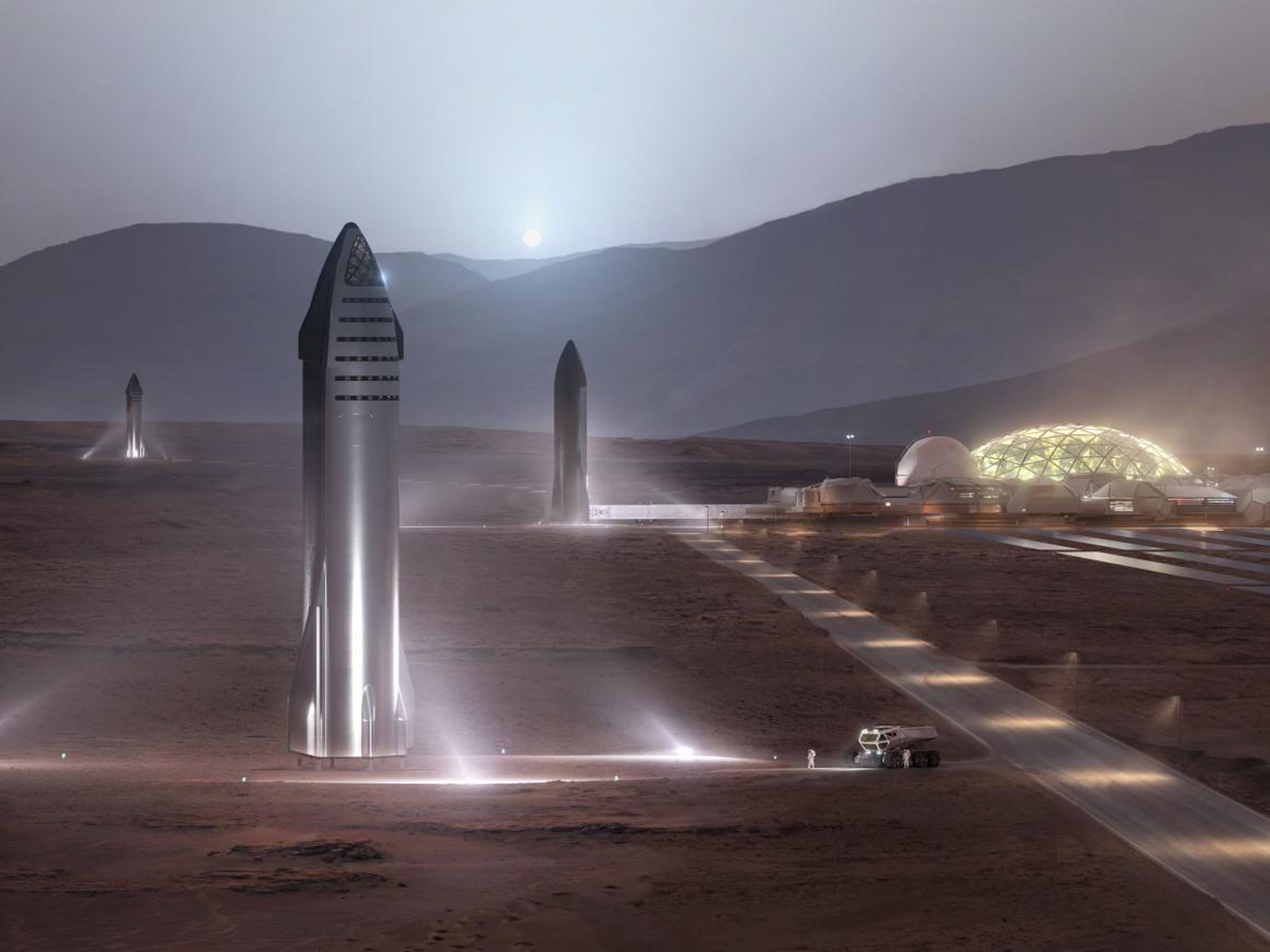 Una ilustración de los cohetes Starship proyectados por SpaceX en las plataformas de lanzamiento de una ciudad de Marte.