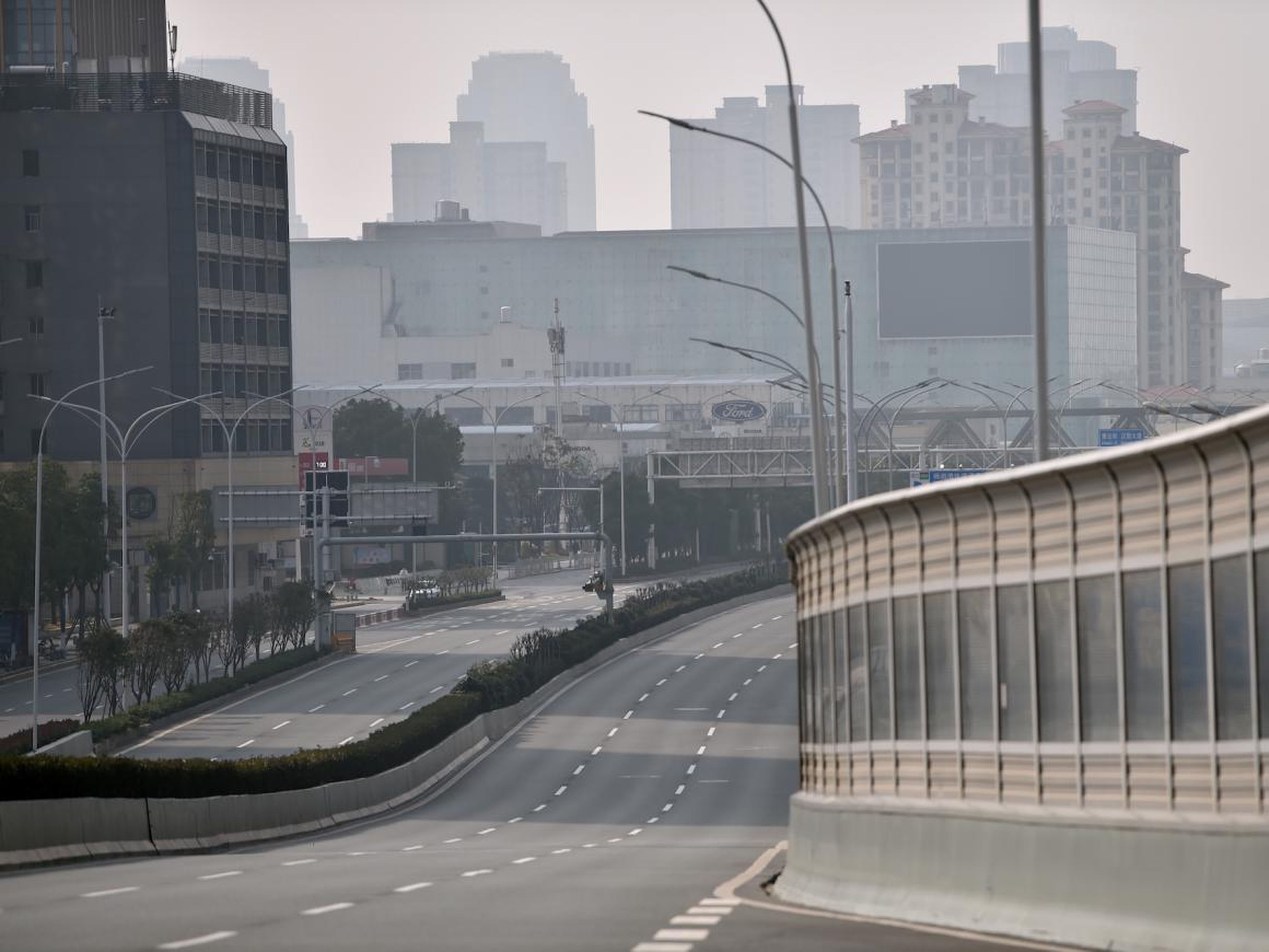 A major road going through the streets of the city remains deserted as people stay at home and avoid transport due to the virus outbreak in the city of Wuhan in Hubei province on January 29, 2020.