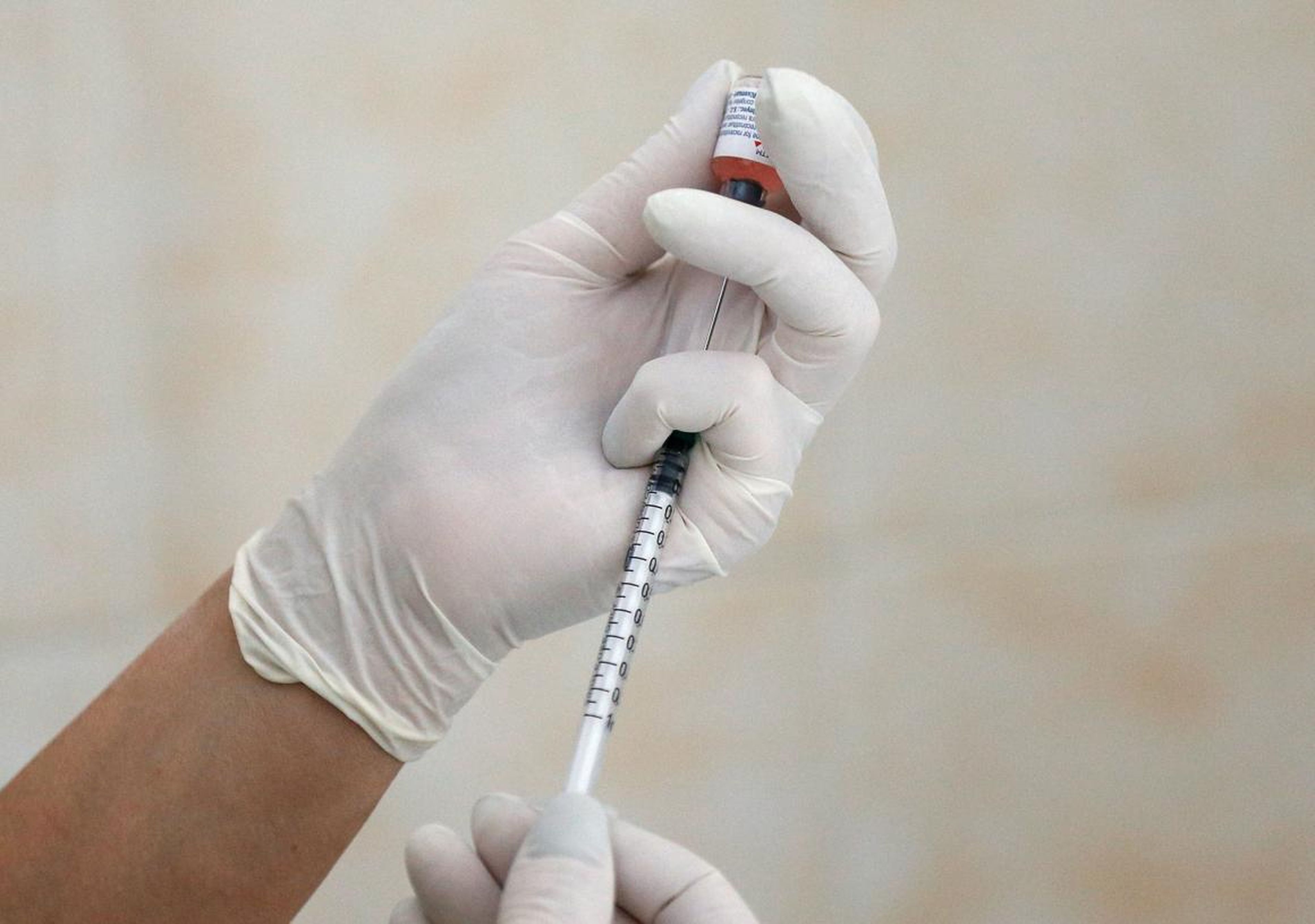 A nurse fills a syringe with a vaccine before administering an injection at a children's clinic in Kiev, Ukraine.