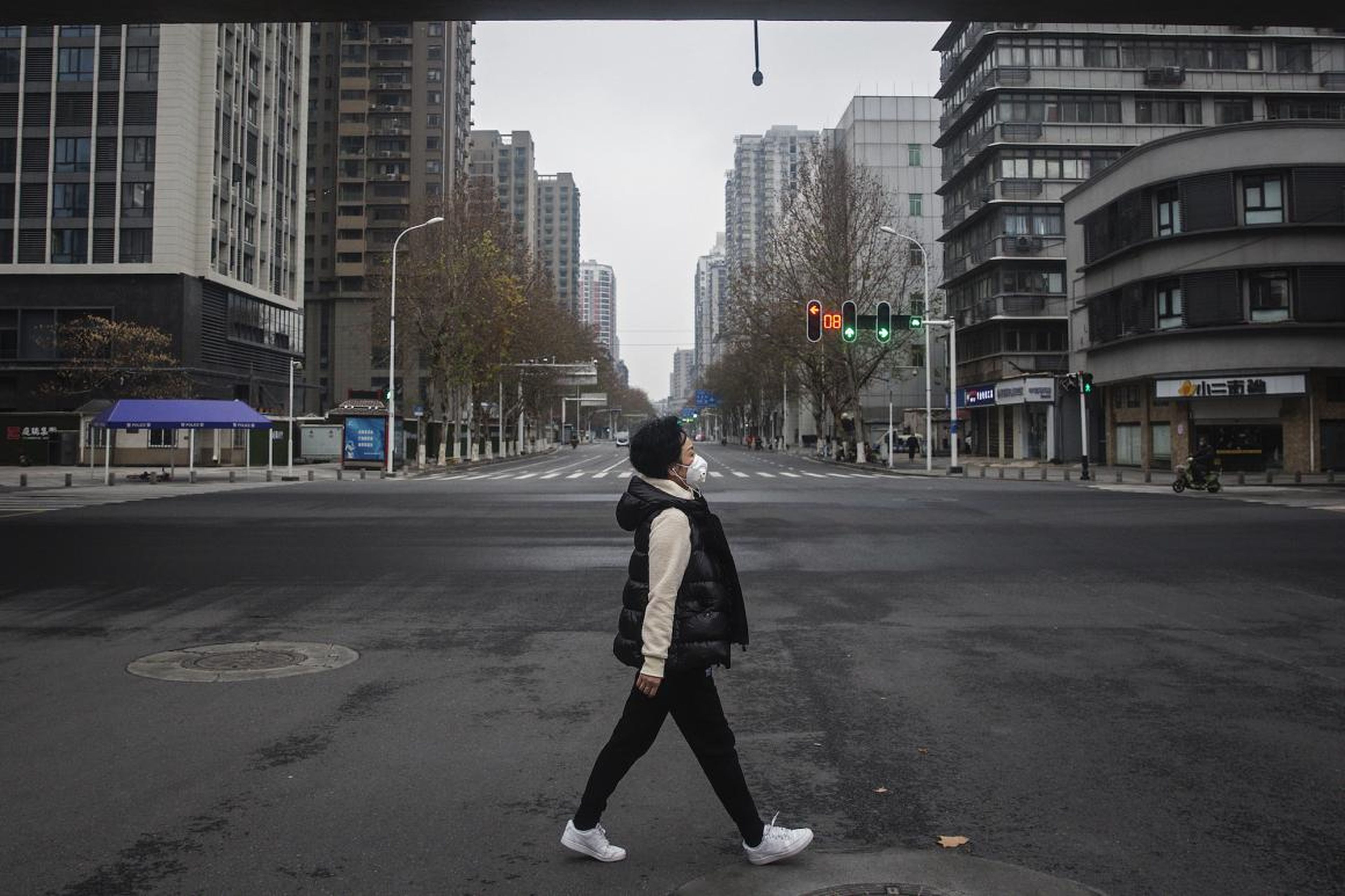 A woman walks on an empty road on January 27, 2020 in Wuhan, China. As the death toll from the coronavirus reaches 80 in China with over 2700 confirmed cases, the city remains on lockdown for a fourth day.