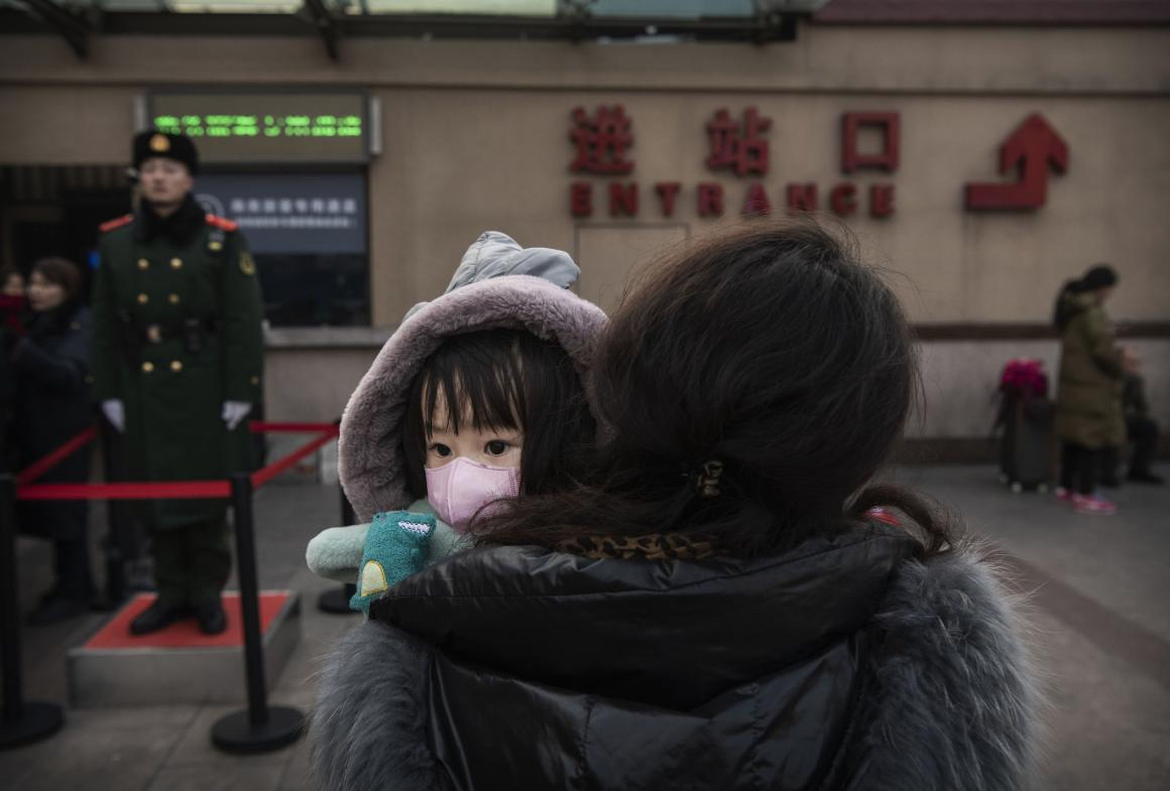 A girl wearing a face mask at Beijing's central railway station.