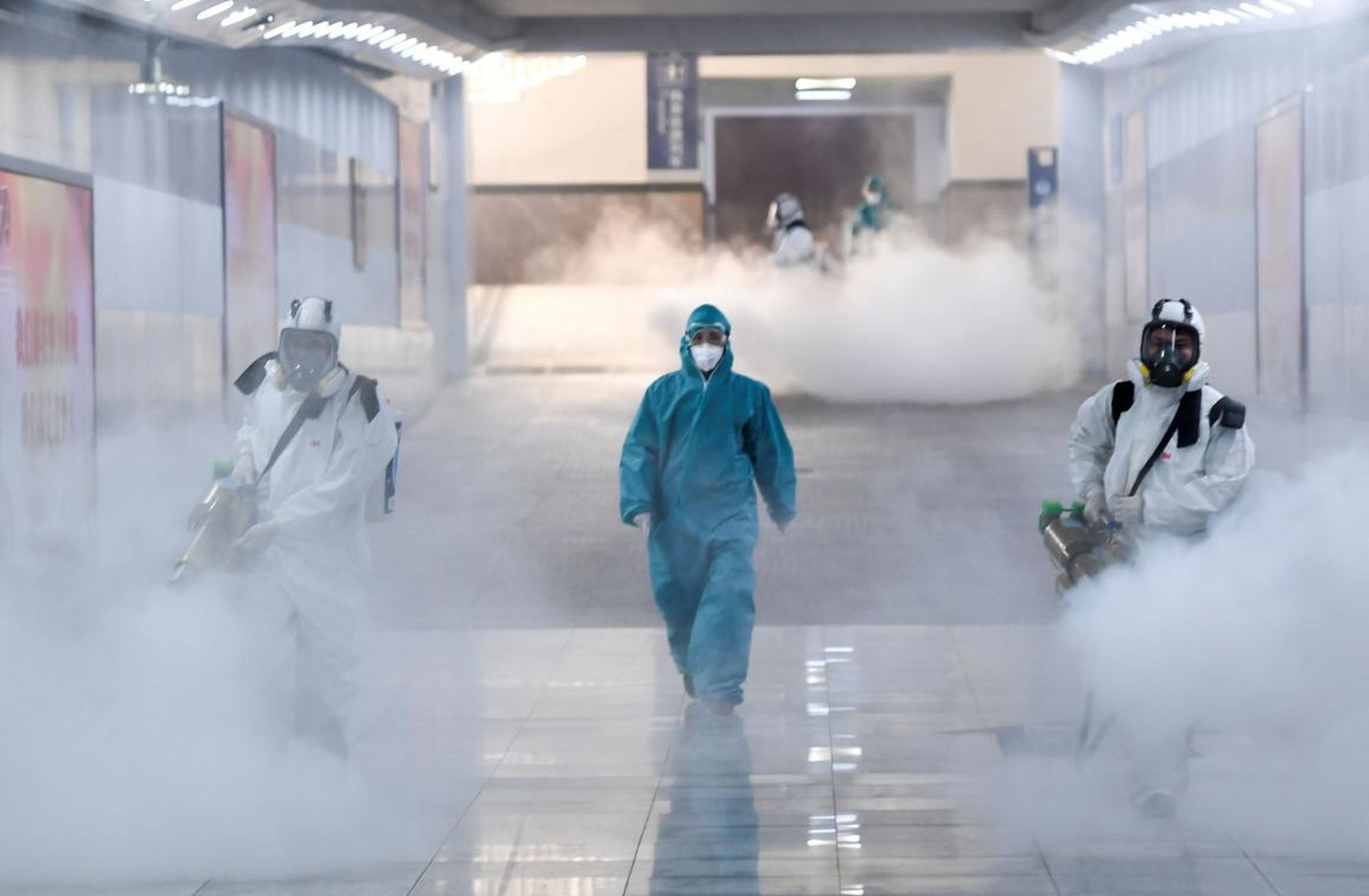 Volunteers in protective suits disinfect a railway station as the country is hit by an outbreak of the new coronavirus, in Changsha, Hunan province, China February 4, 2020.