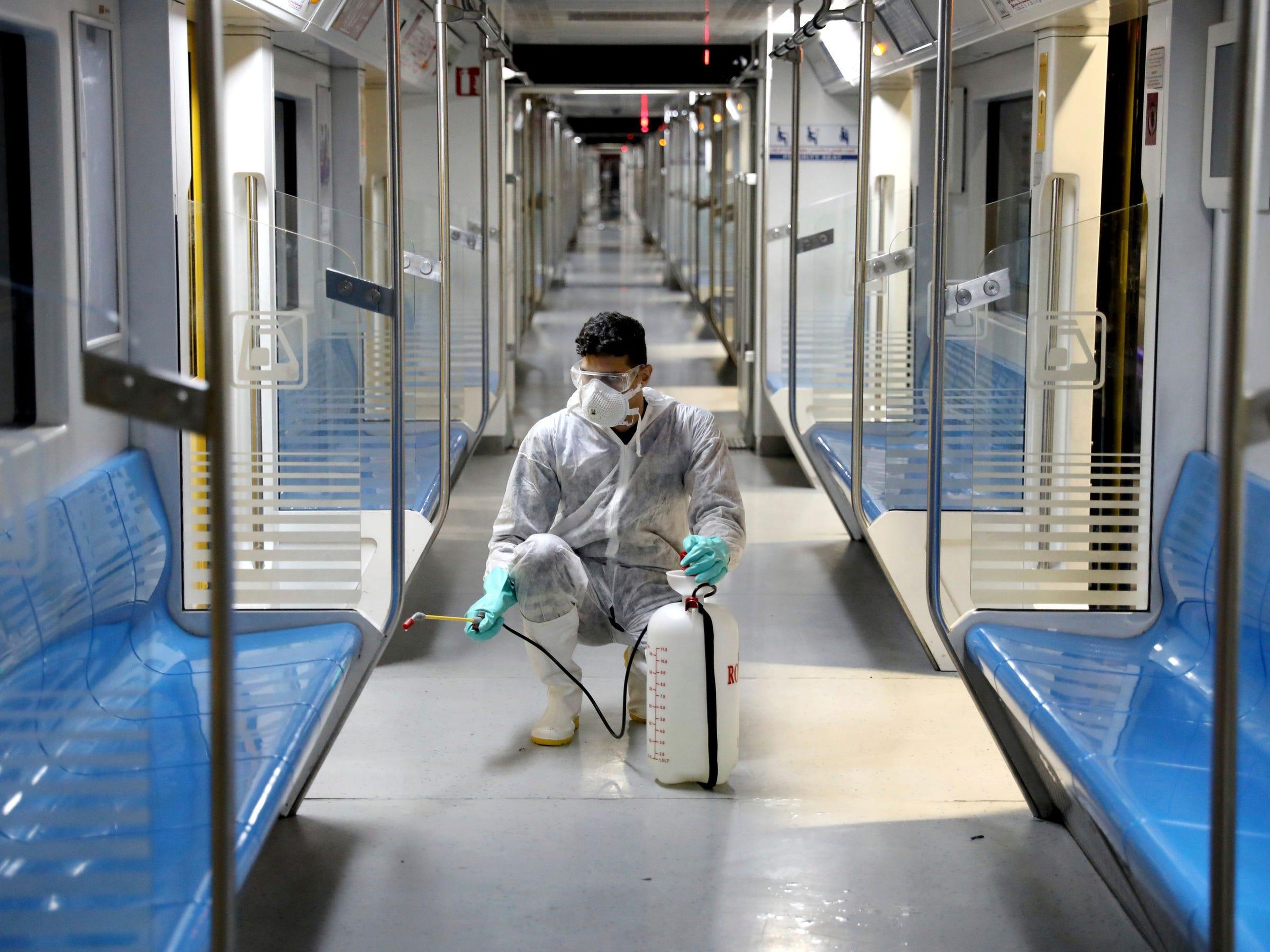 A worker disinfects subway trains.