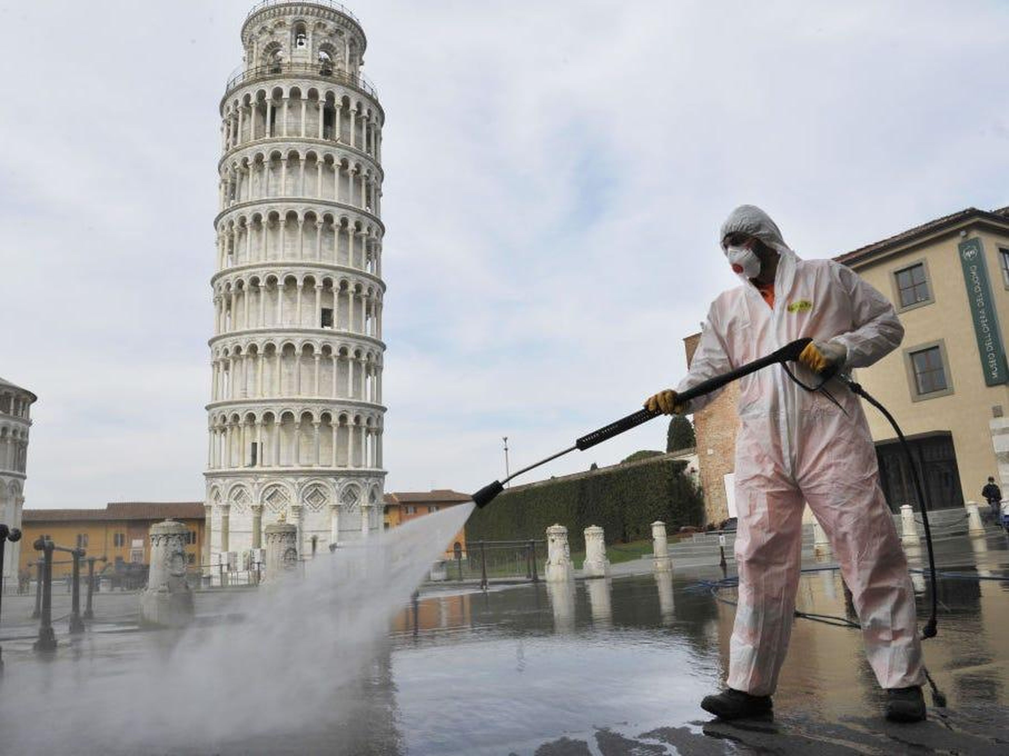 AFTER: The only people around the Leaning Tower during Italy's lockdown are workers spraying disinfectant solutions around public spaces.