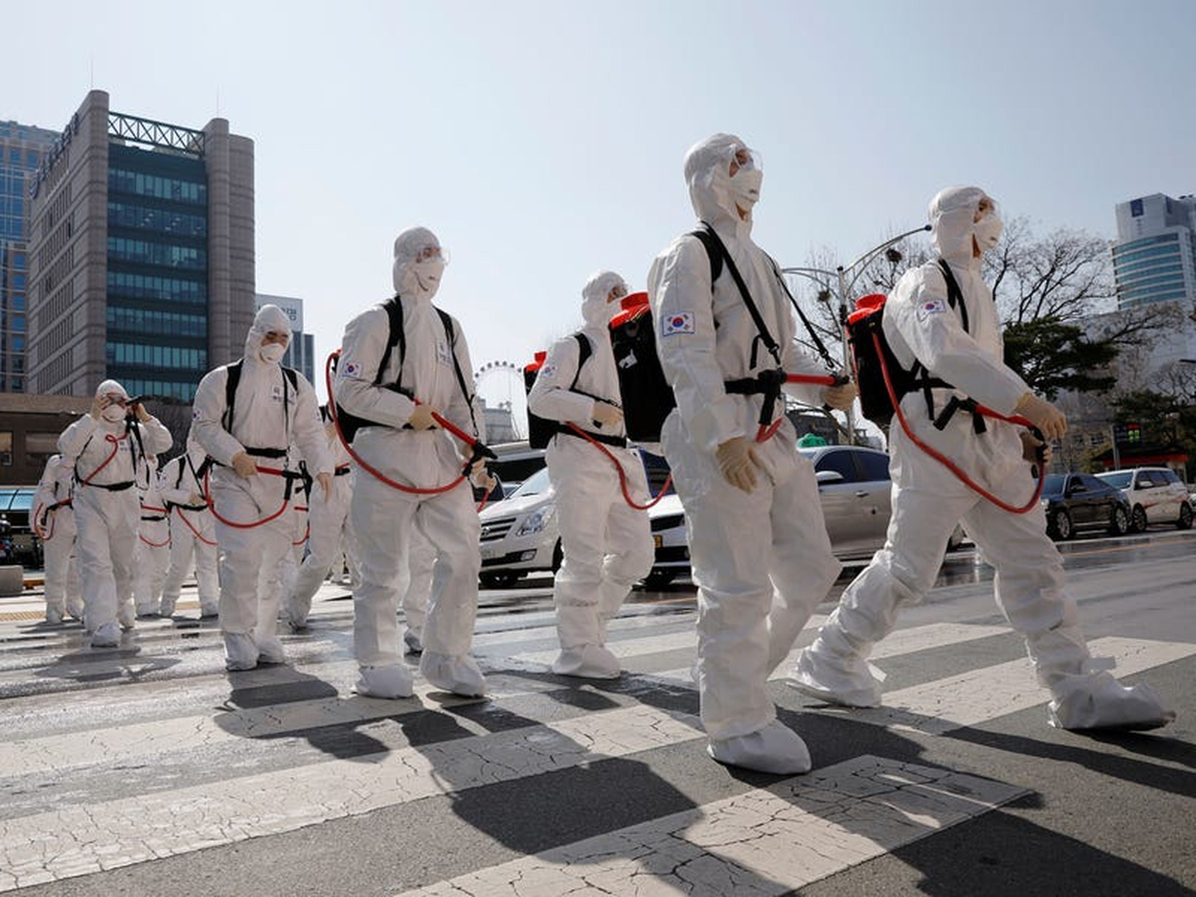 Soldados surcoreanos con equipo de protección caminan en una calle frente al ayuntamiento de Daegu después del rápido aumento de los casos confirmados de coronavirus el 2 de marzo de 2020.