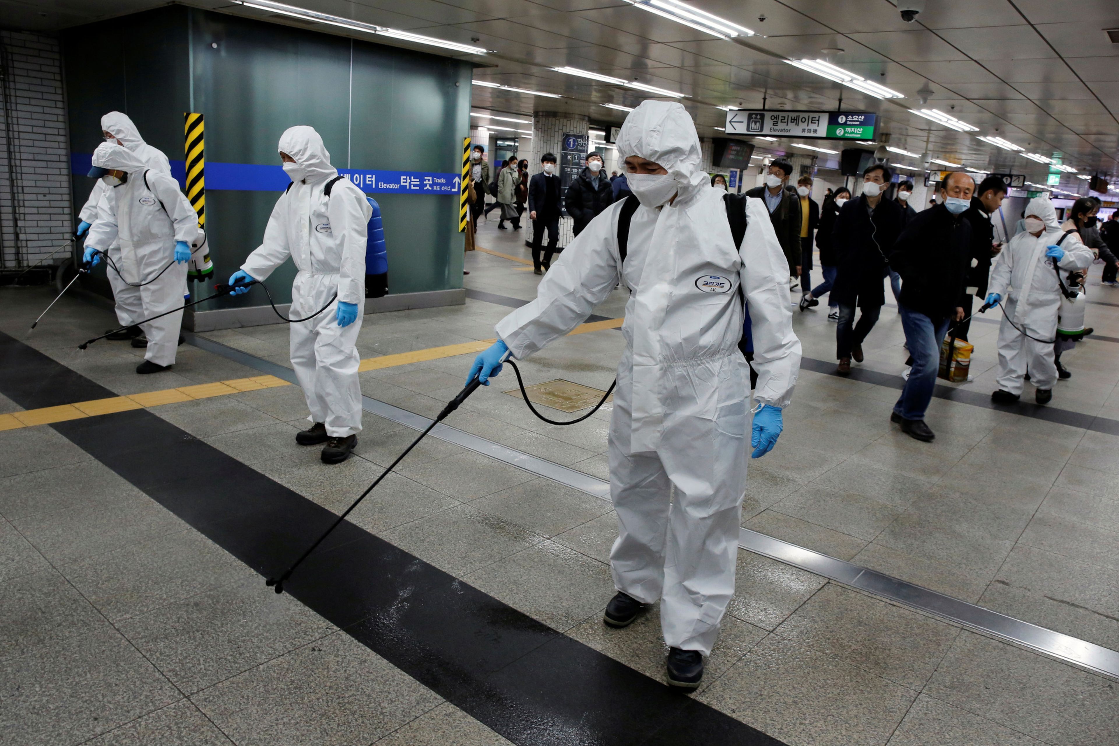 Trabajadores desinfectan desinfectan una estación de metro en medio de los temores de coronavirus en Seúl, Corea del Sur el 11 de marzo de 2020.