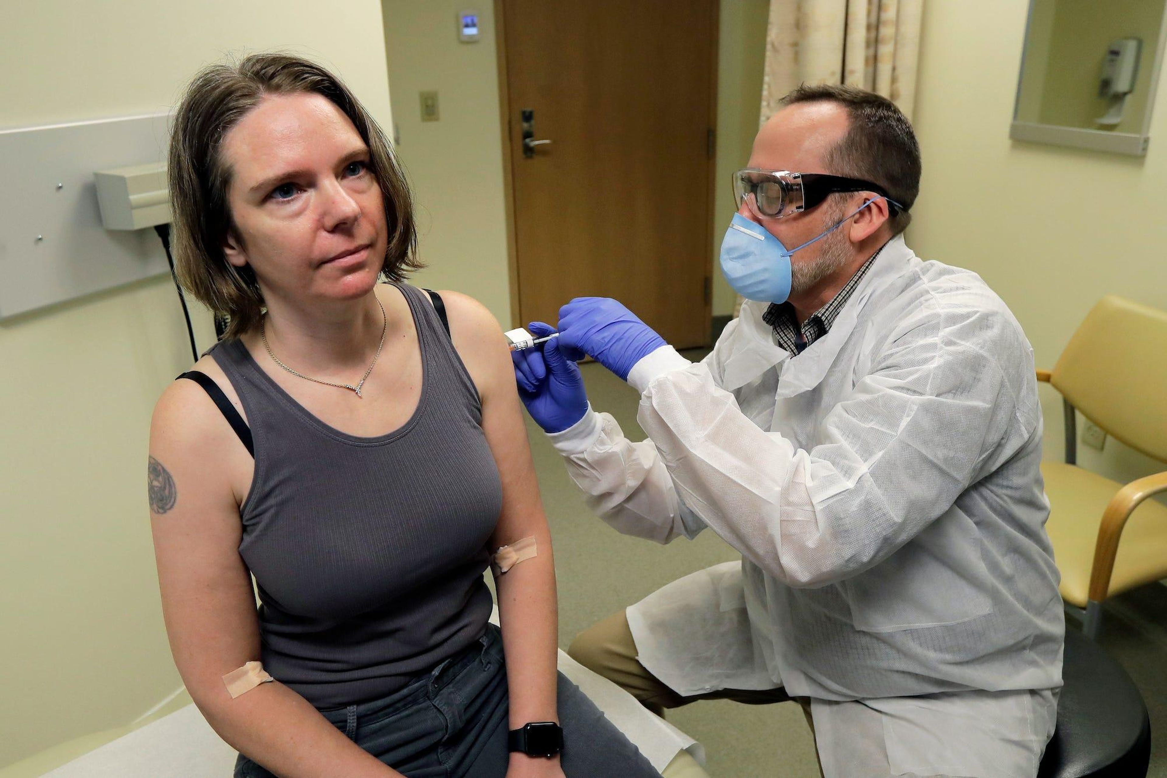 A pharmacist gives Jennifer Haller the first shot in the first-stage safety study clinical trial of a vaccine for COVID-19.