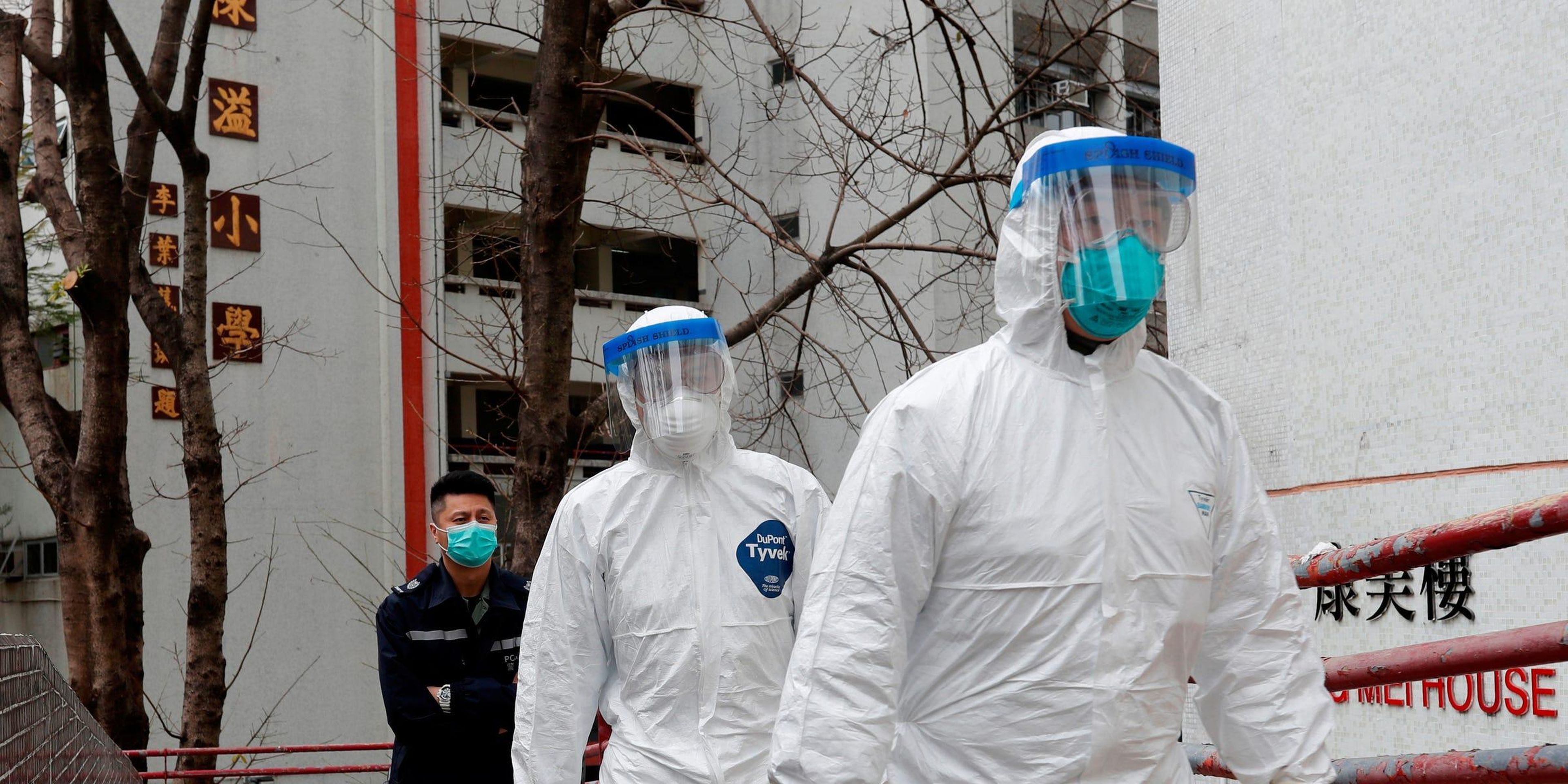 Health workers in protective gear at Cheung Hong Estate in Hong Kong in February.