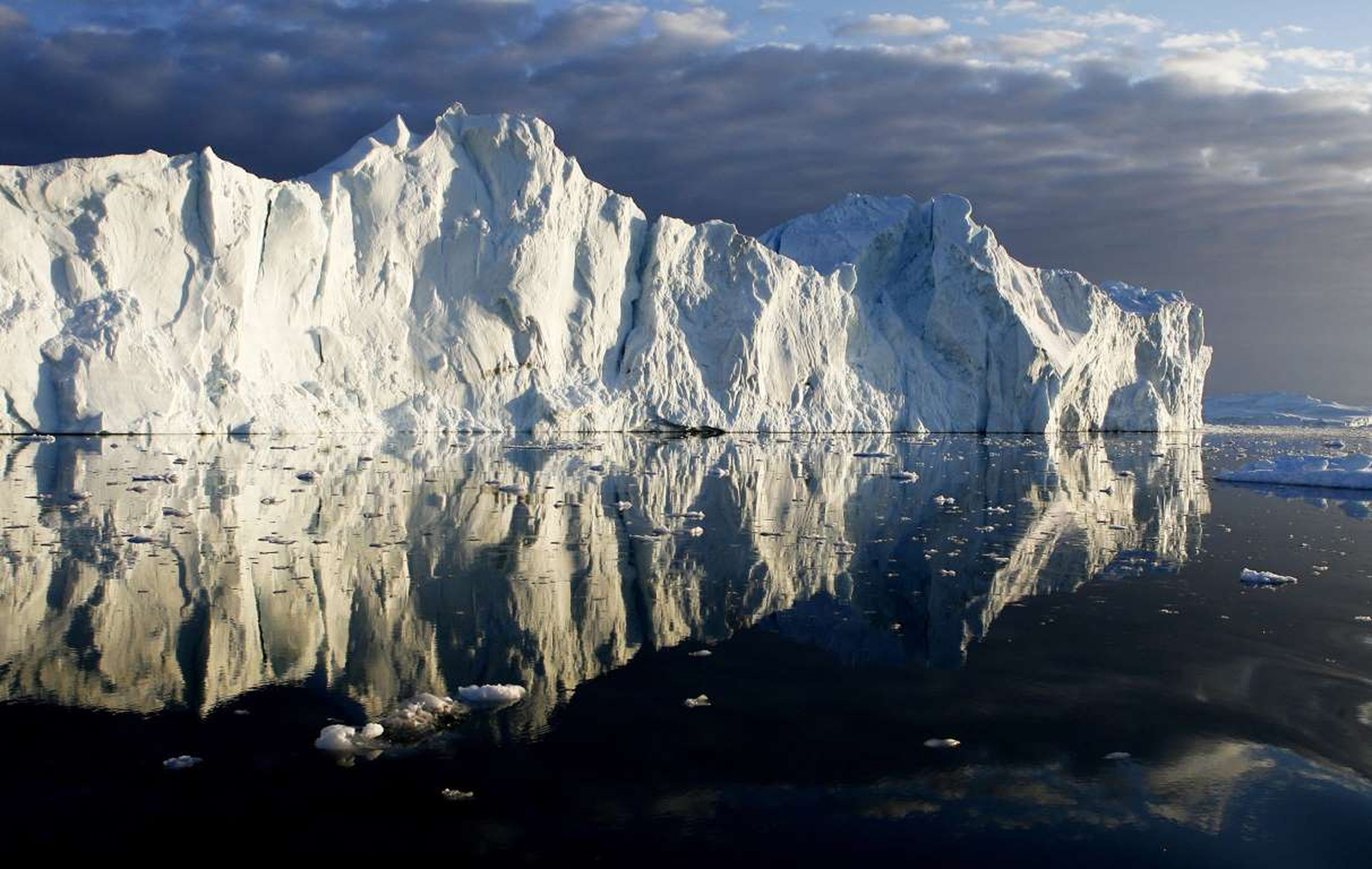 Los icebergs reflejados en el agua de la desembocadura del fiordo helado Jakobshavn, en la costa oeste de Groenlandia.