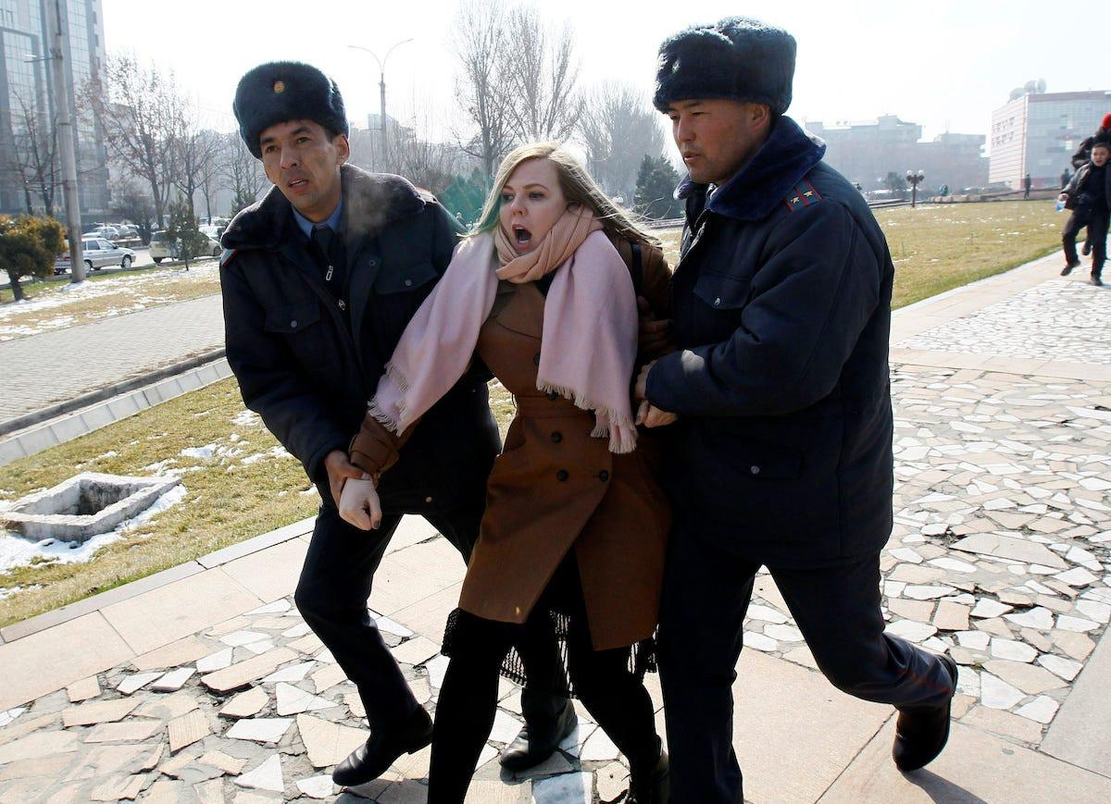 Kyrgyz law enforcement officers detain a women's rights activist during a rally in Bishkek, Kyrgyzstan.