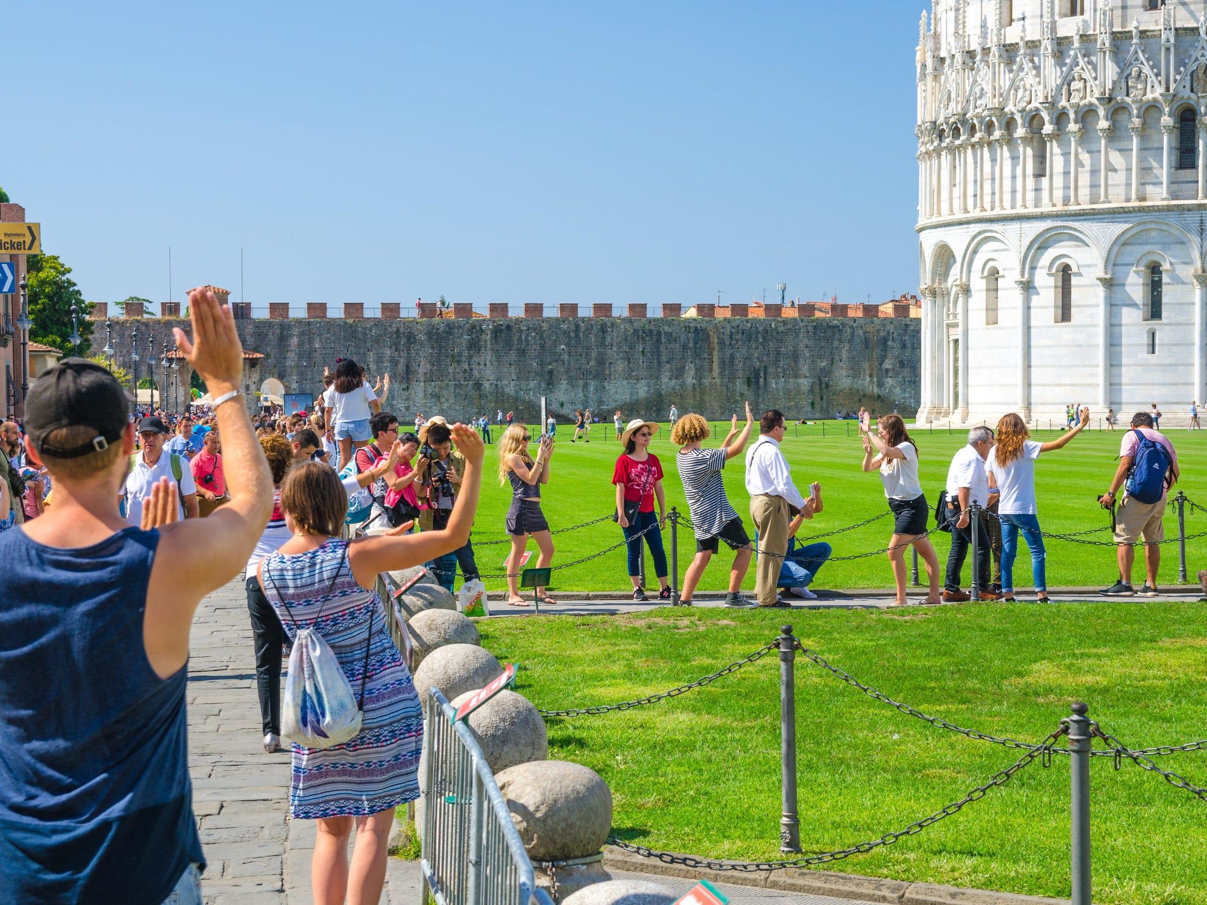 BEFORE: The Leaning Tower of Pisa in Italy attracts throngs of tourists pretending to hold it up.