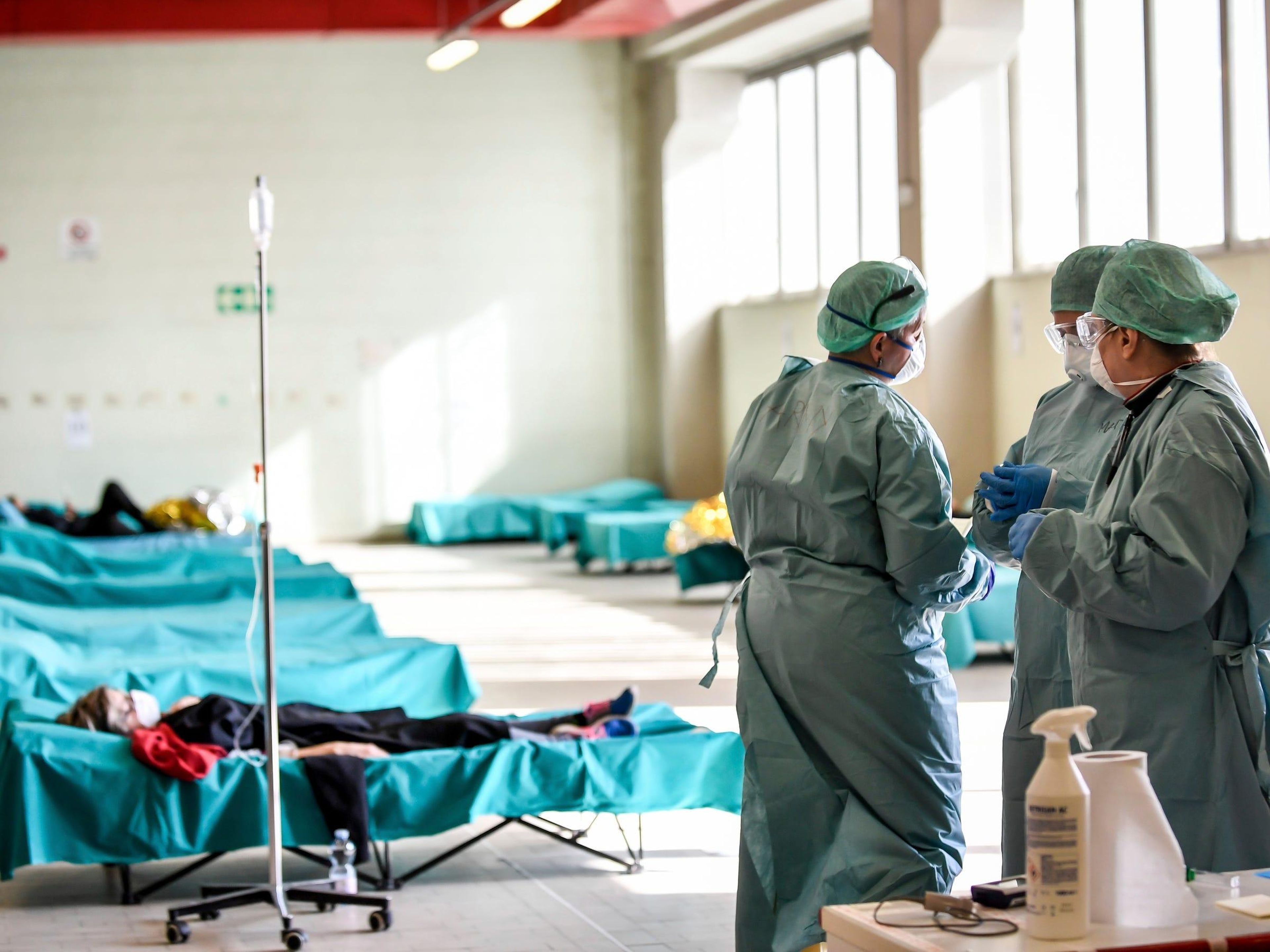 Medical personnel work inside one of the emergency structures that were set up to ease procedures at the hospital of Brescia, Italy, on March 10, 2020.
