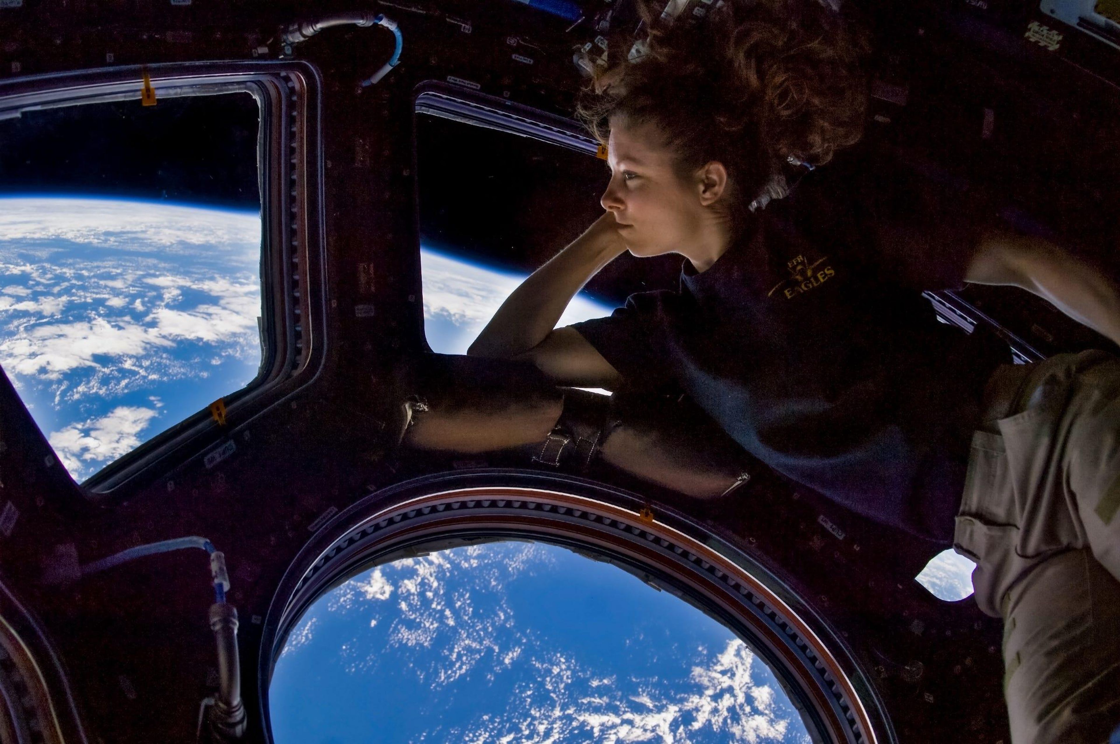 NASA astronaut Tracy Caldwell Dyson, Expedition 24 flight engineer, looks through a window in the Cupola of the International Space Station on September 11, 2010.