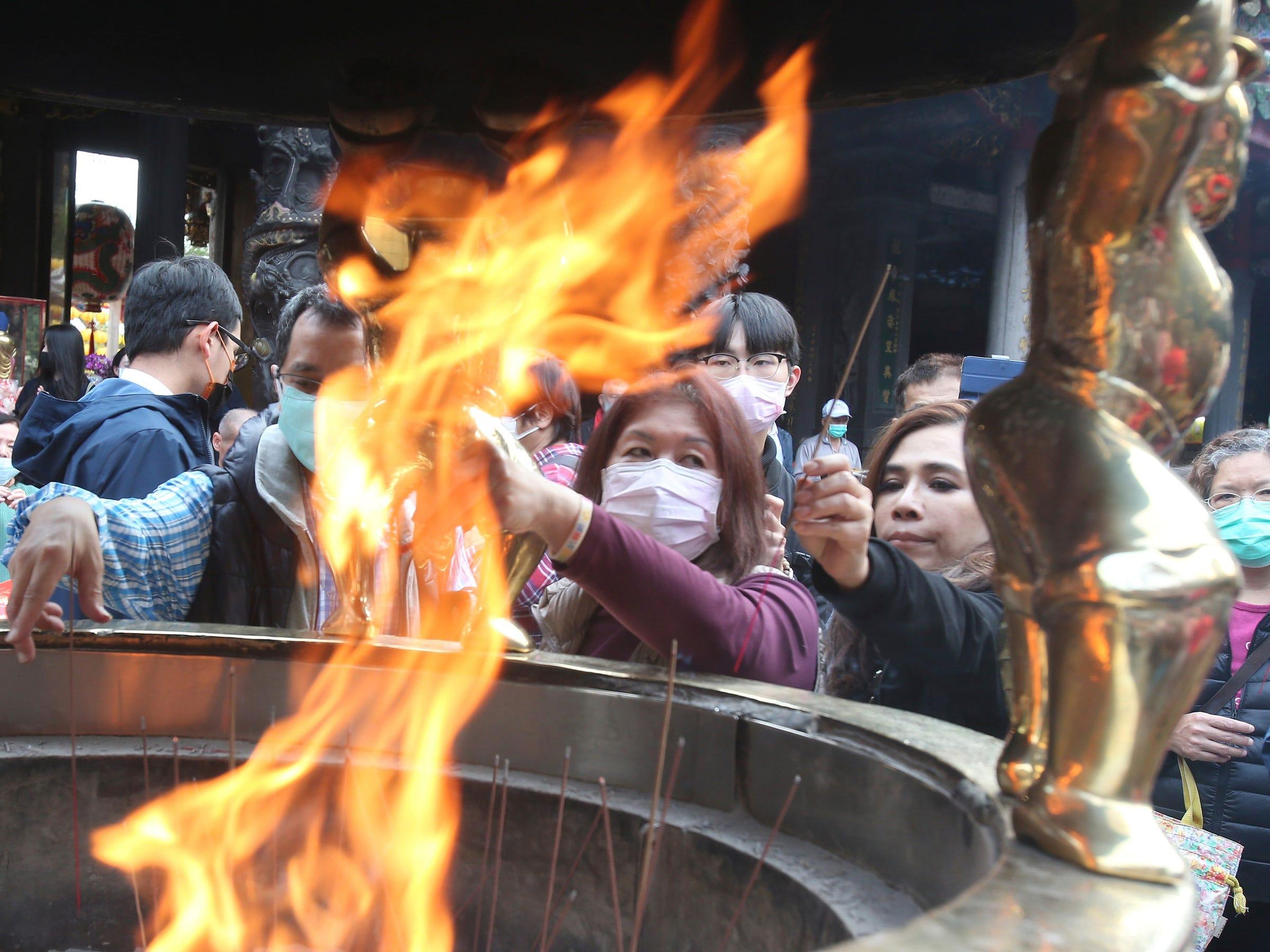 La gente reza en el popular Templo Longshan en Taipei el jueves.