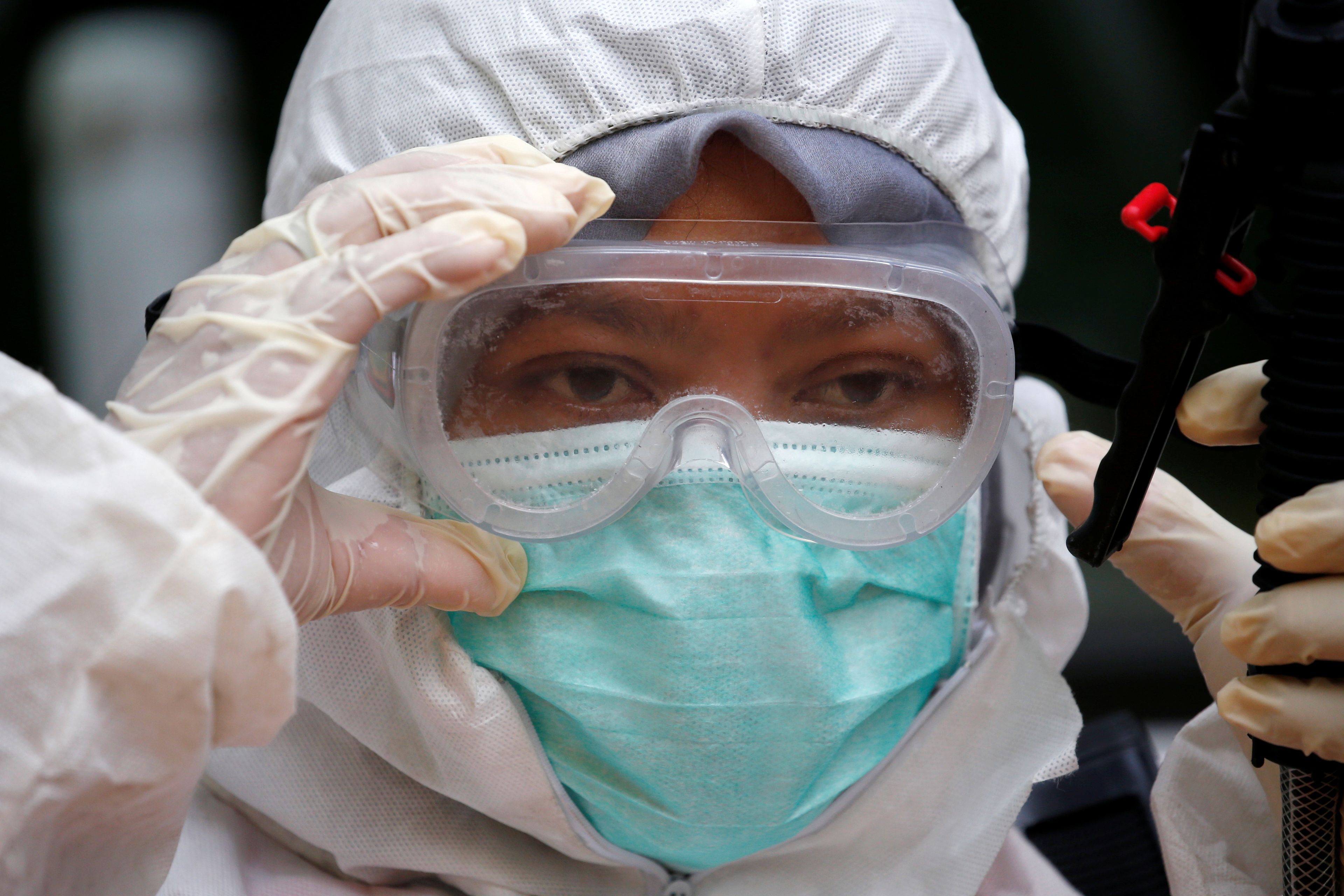 Un voluntario de Indonesia con un traje de protección para el coronavirus.