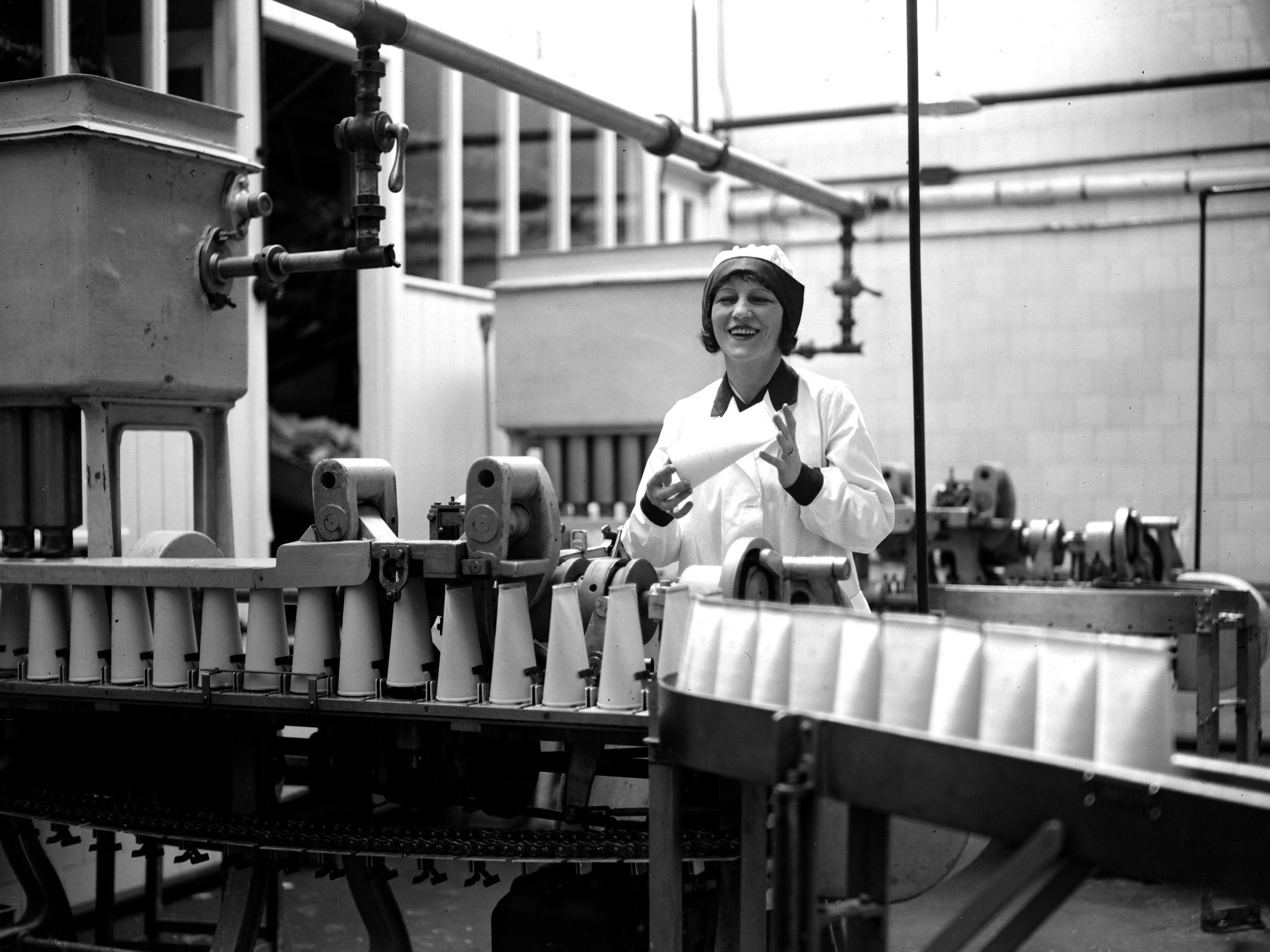 Una mujer en una planta de embotellado de leche en la década de 1920.