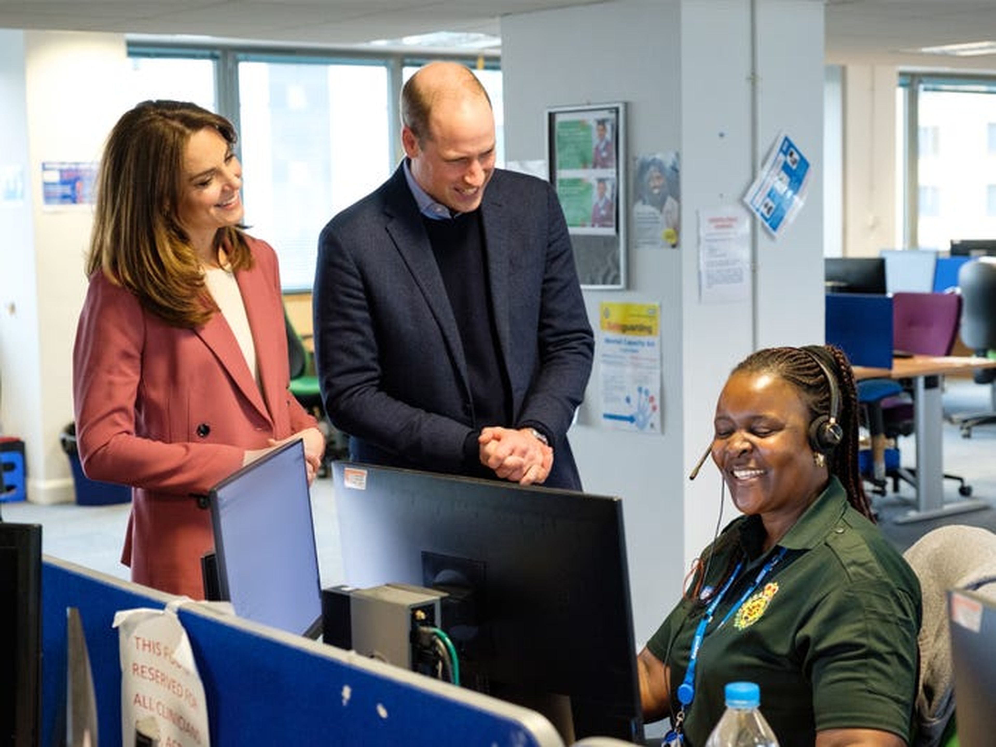 Kate Middleton y el Príncipe Guillermo se reúnen con el personal en una sala de control de ambulancias.
