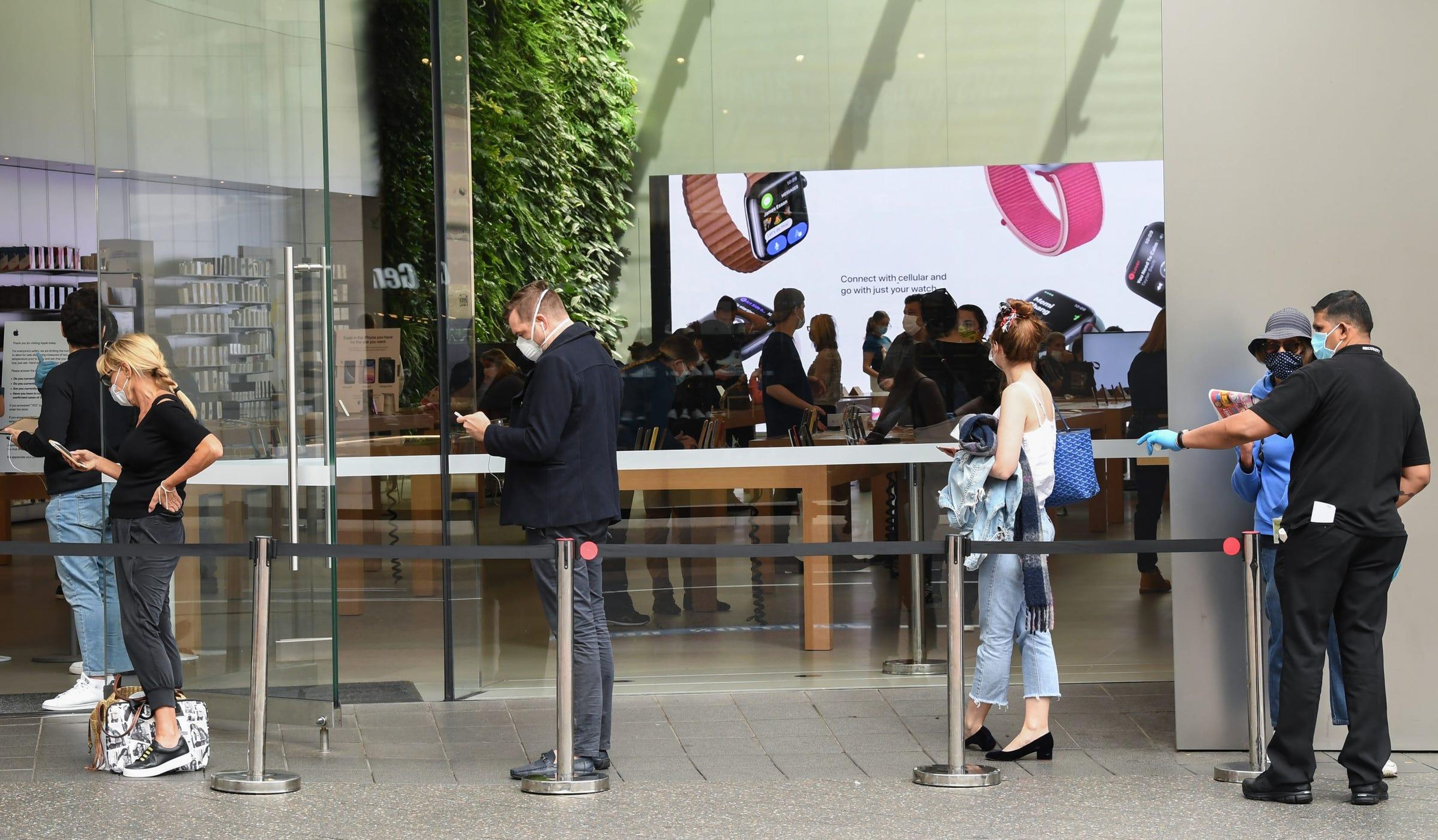 Apple customers social distance in a line outside the Apple Store at Bondi Junction on May 07, 2020, in Sydney, Australia.
