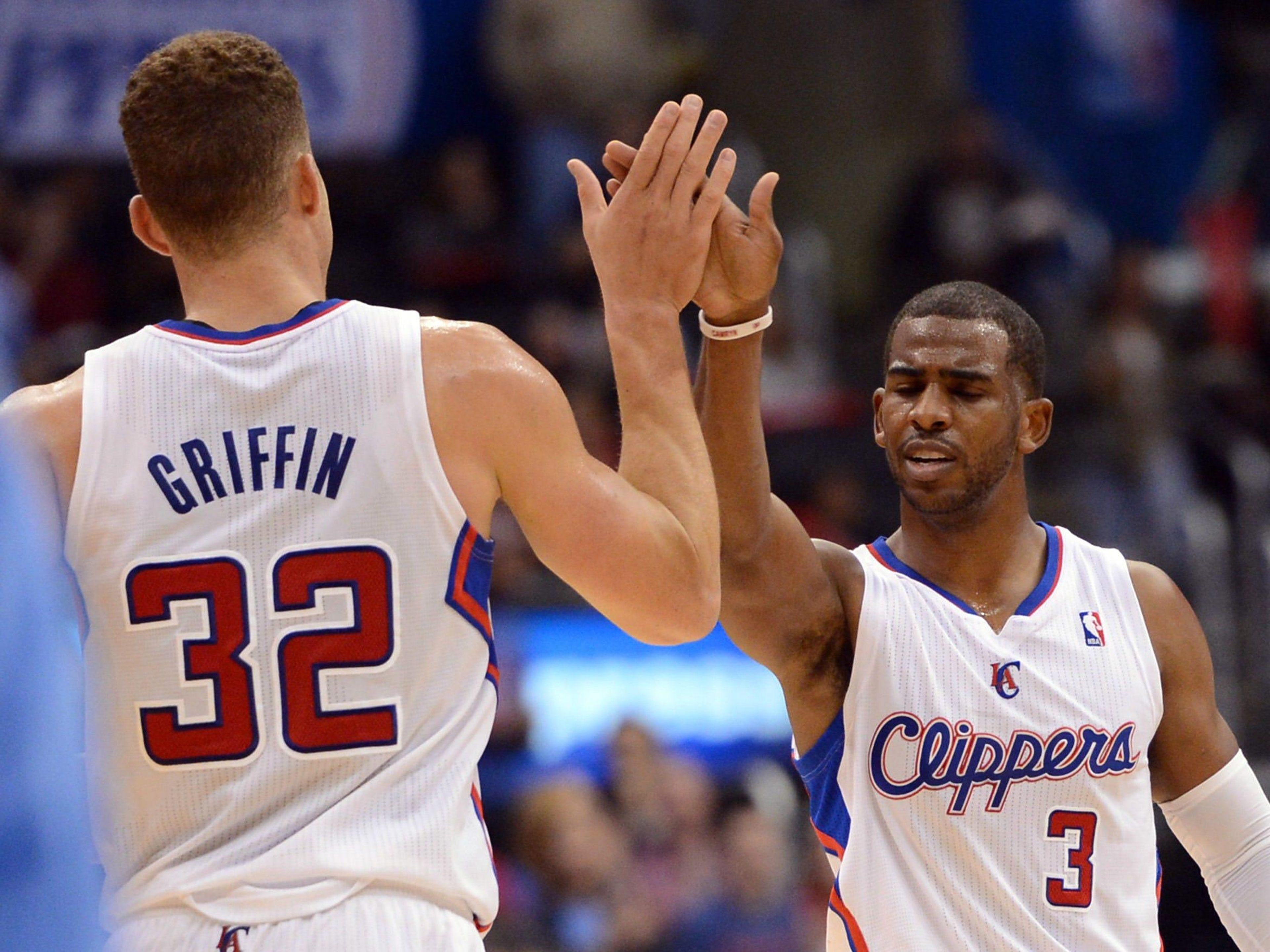 LA Clippers players high-five each other.