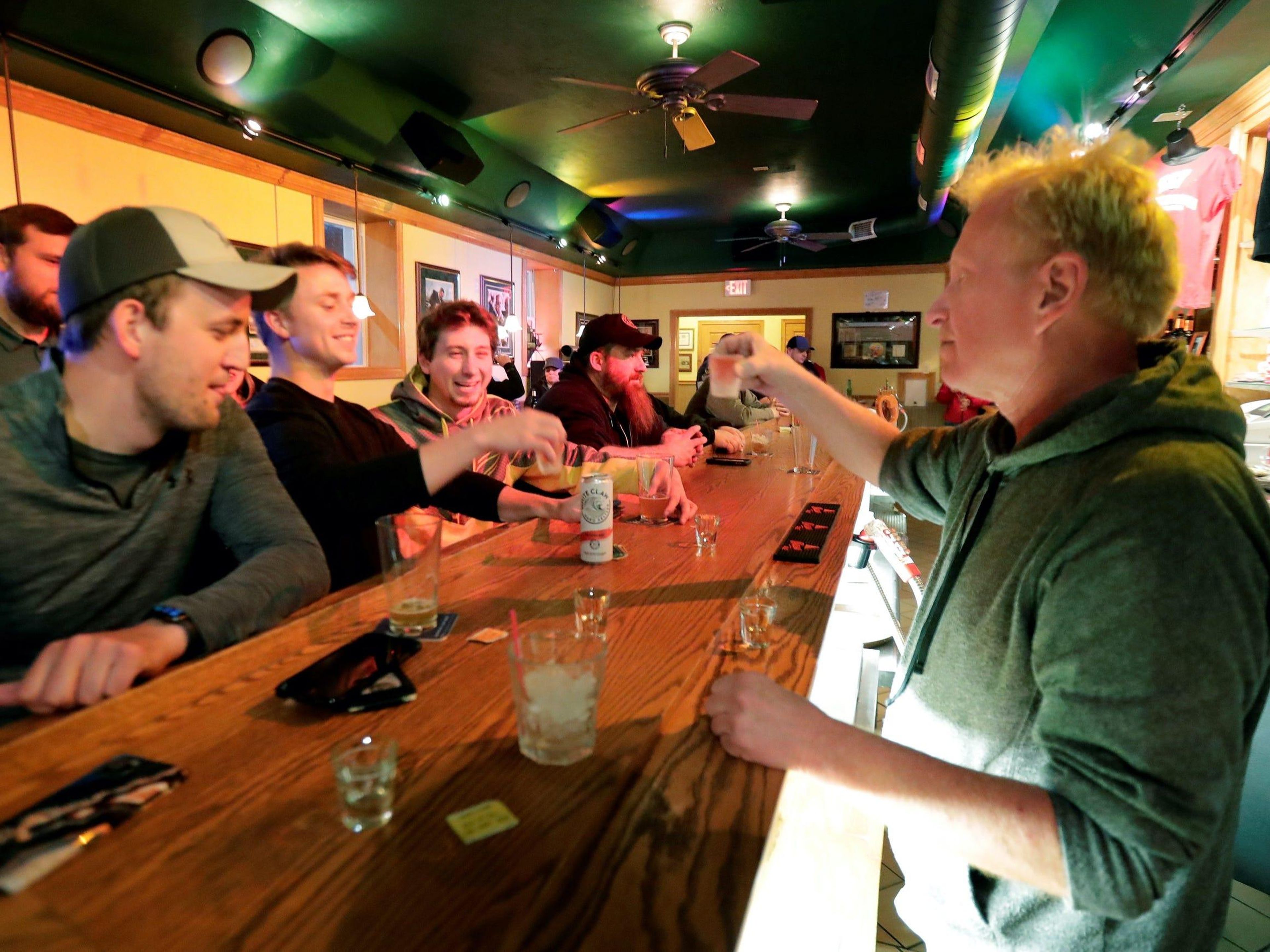 People toast the reopening of the Friends and Neighbors bar in Appleton, Wisconsin, following the Wisconsin Supreme Court's decision to strike down Gov. Tony Evers' safer-at-home order on May 13.