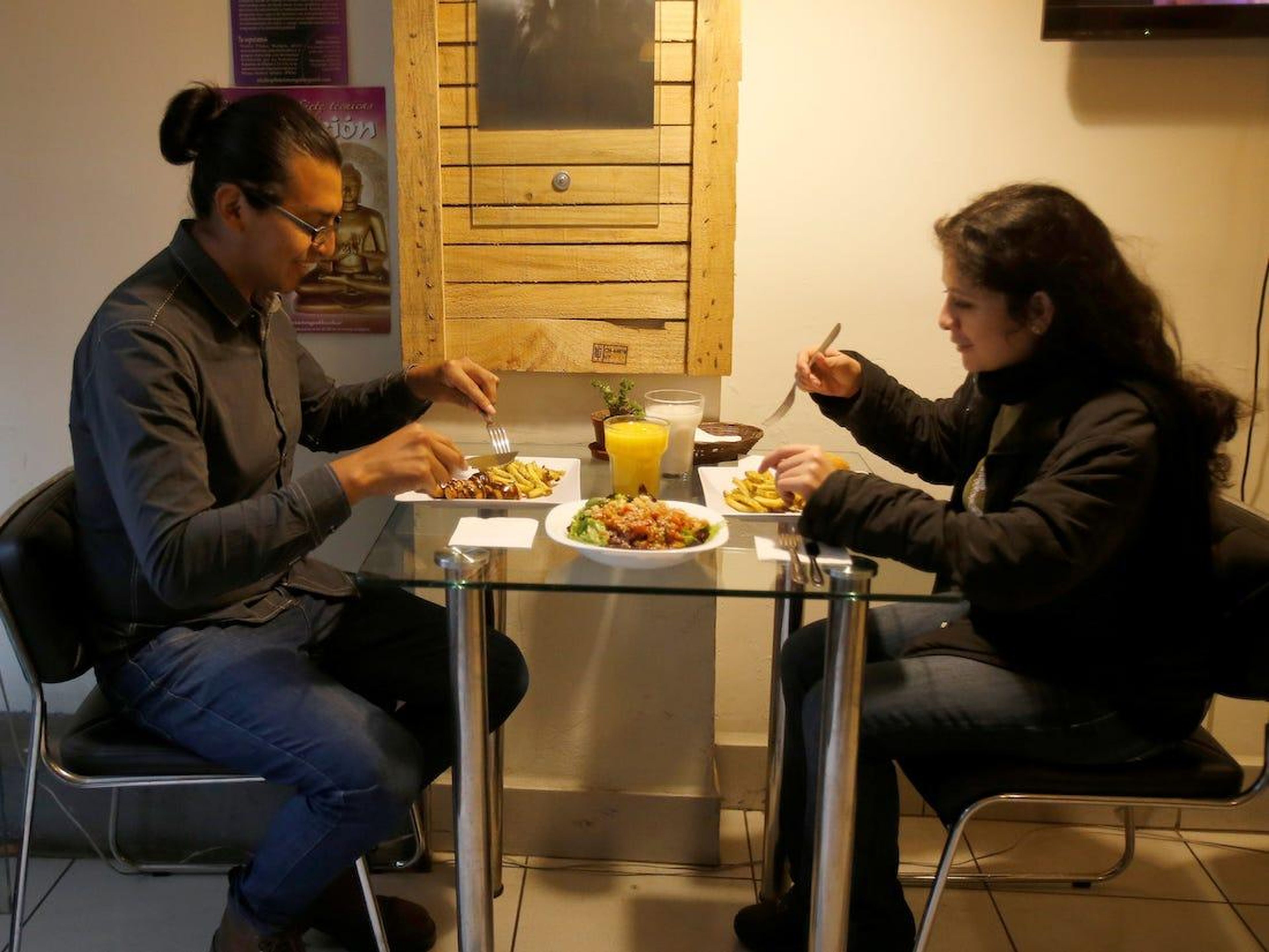Two people eating.