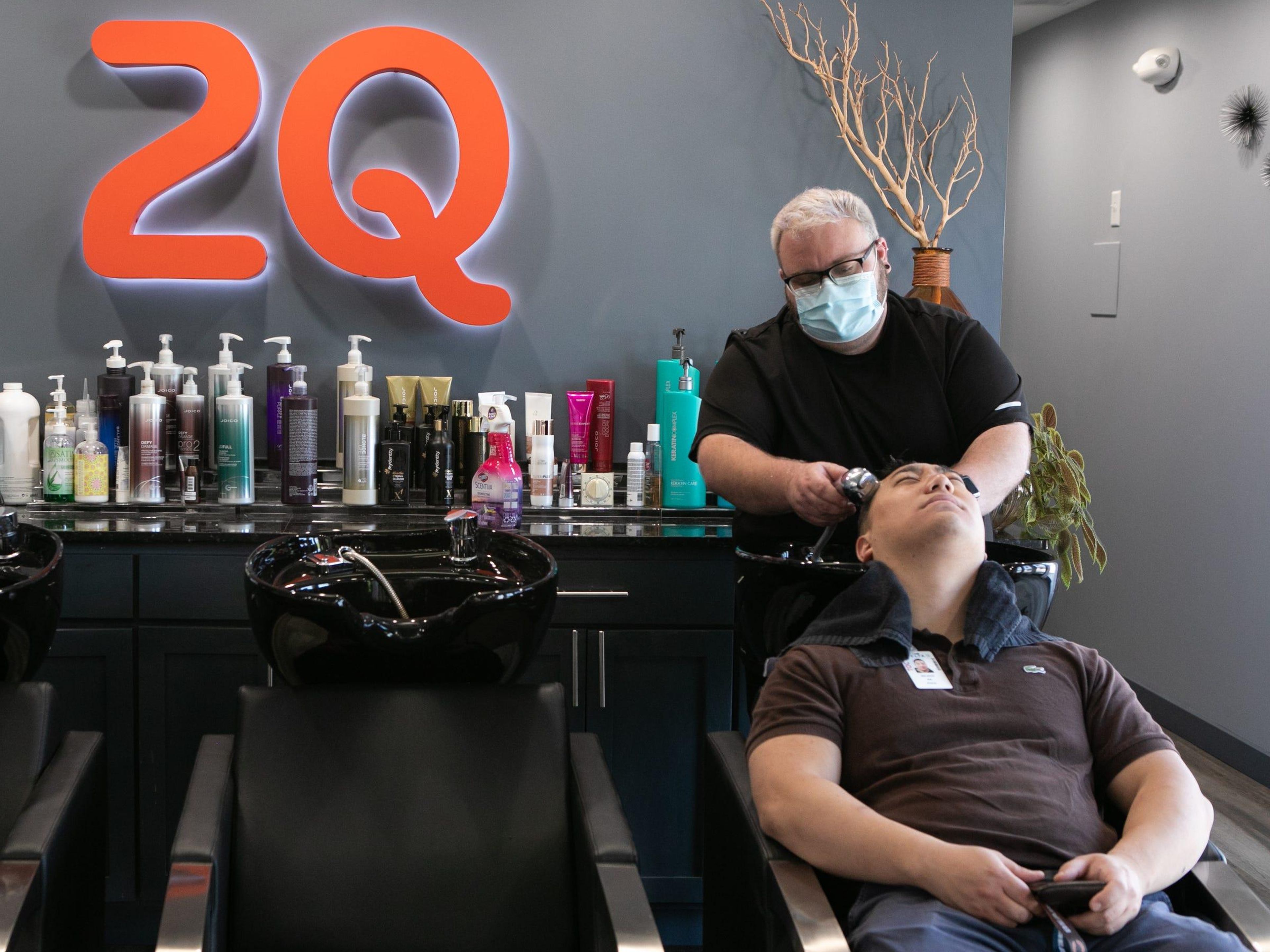 A man washes a customer's hair at a hair salon in Atlanta on April 27.