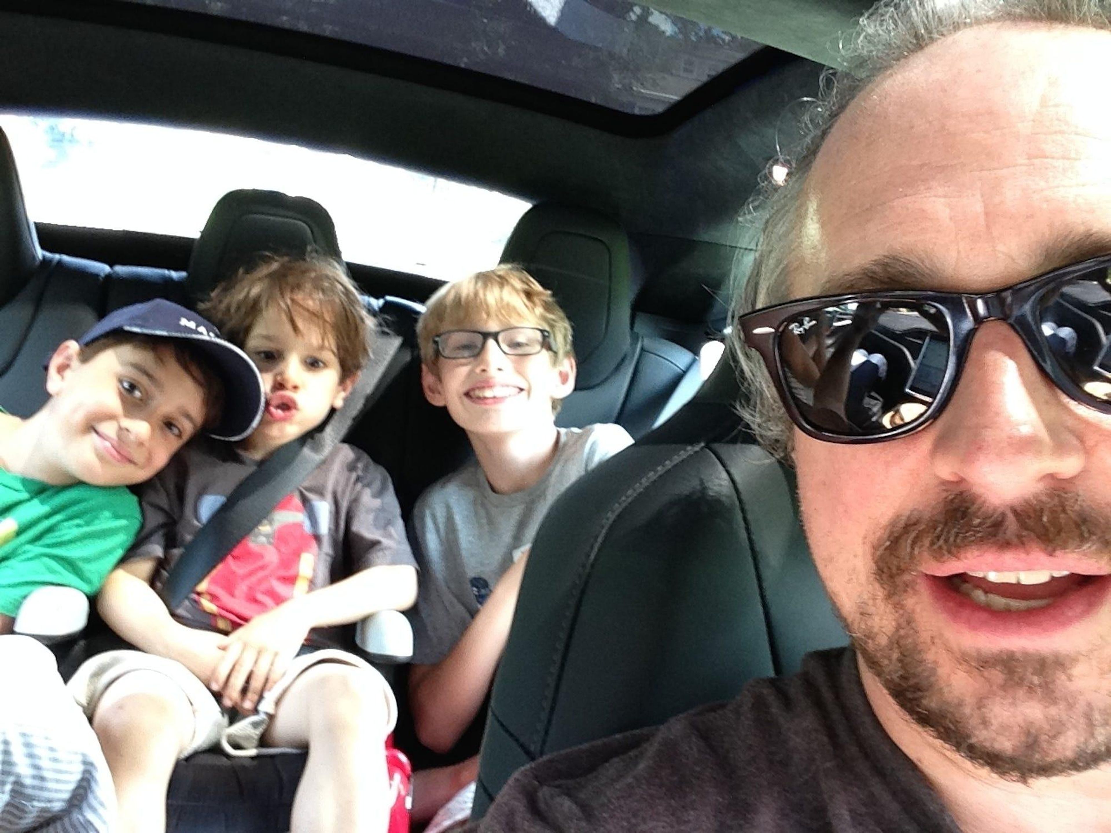 The Model S has ample space in the back seat for three kids, and two adults would be relatively comfortable.