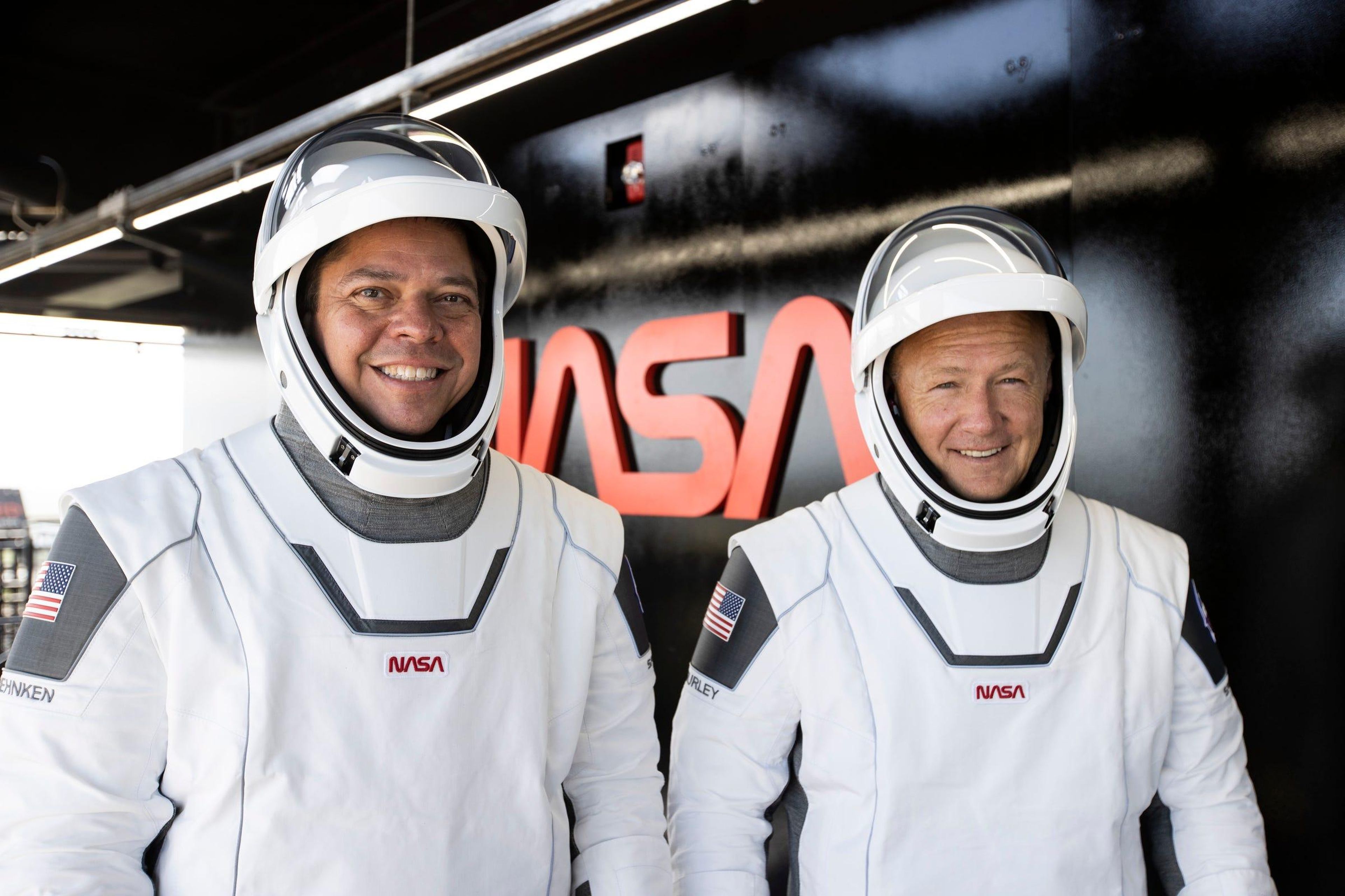 NASA astronauts Bob Behnken (left) and Doug Hurley wear their spacesuits during a dress rehearsal on May 23, 2020, ahead of NASA’s SpaceX Demo-2 mission to the International Space Station.