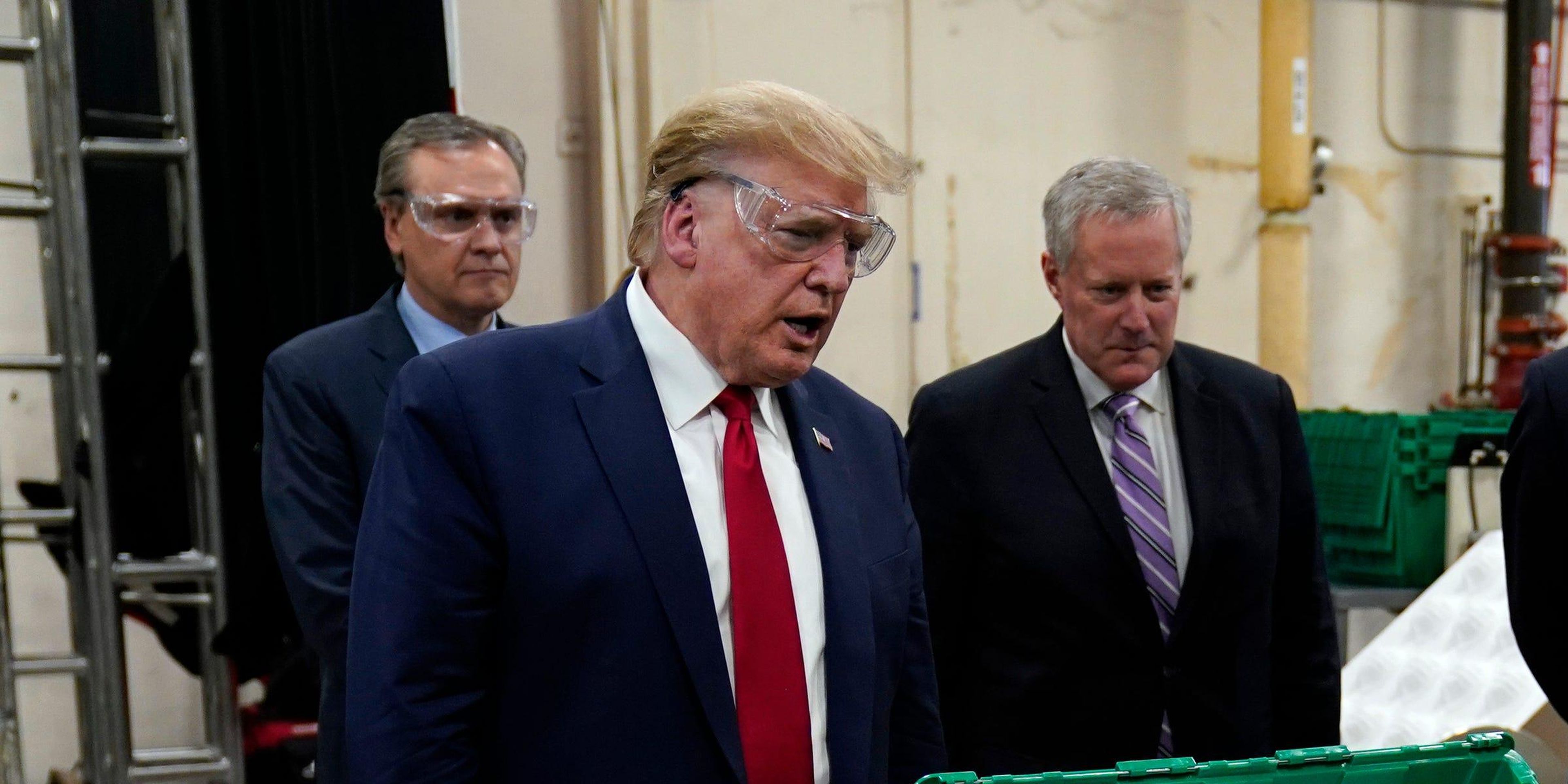 President Donald Trump, Honeywell International VP Tony Stallings, and White House chief of staff Mark Meadows tour a Honeywell plant manufacturing personal protective equipment in Phoenix, Arizona, on May 5, 2020.