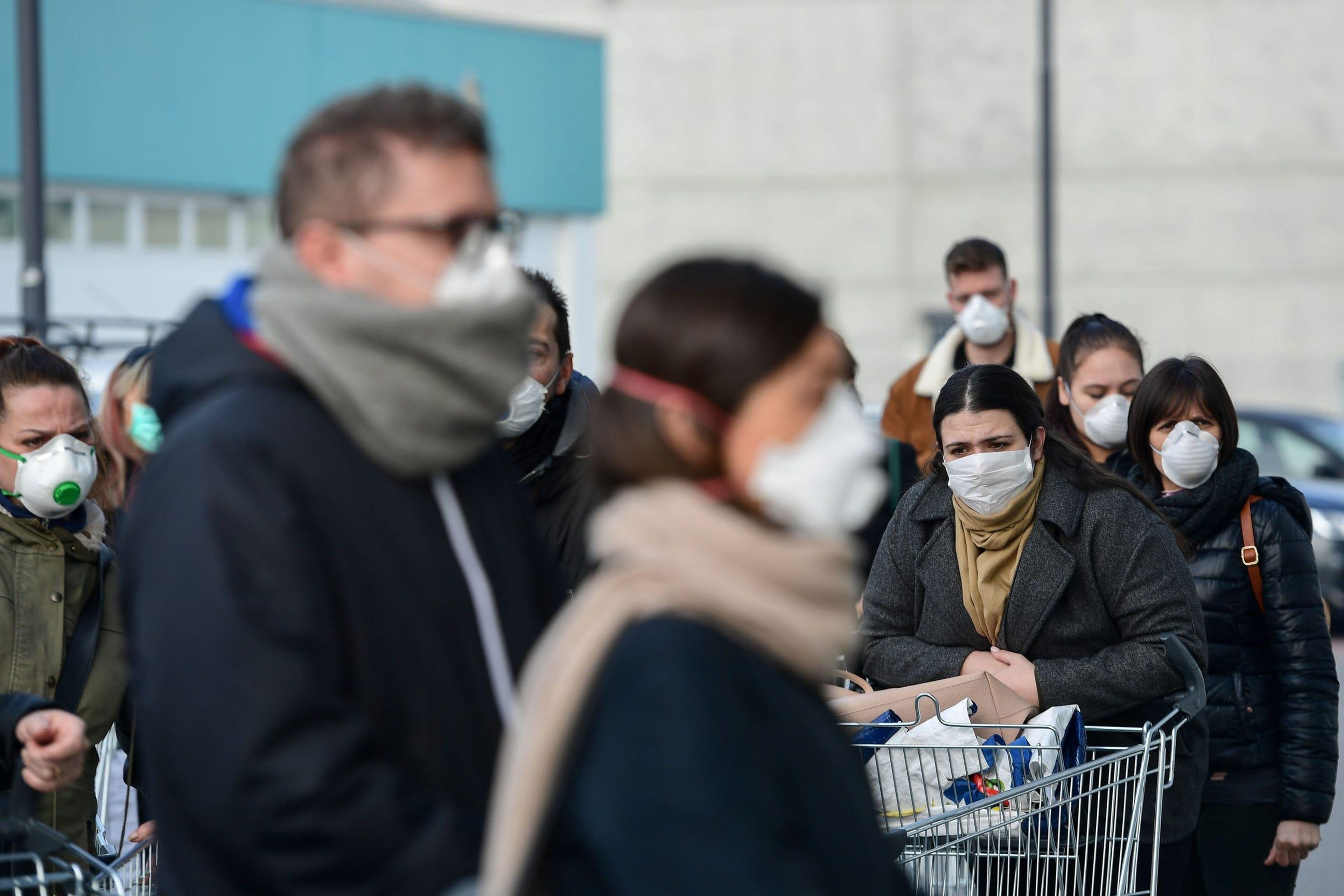 Residents wait to be given access to shop in a supermarket in small groups of forty people on February 23 in the small Italian town of Casalpusterlengo.