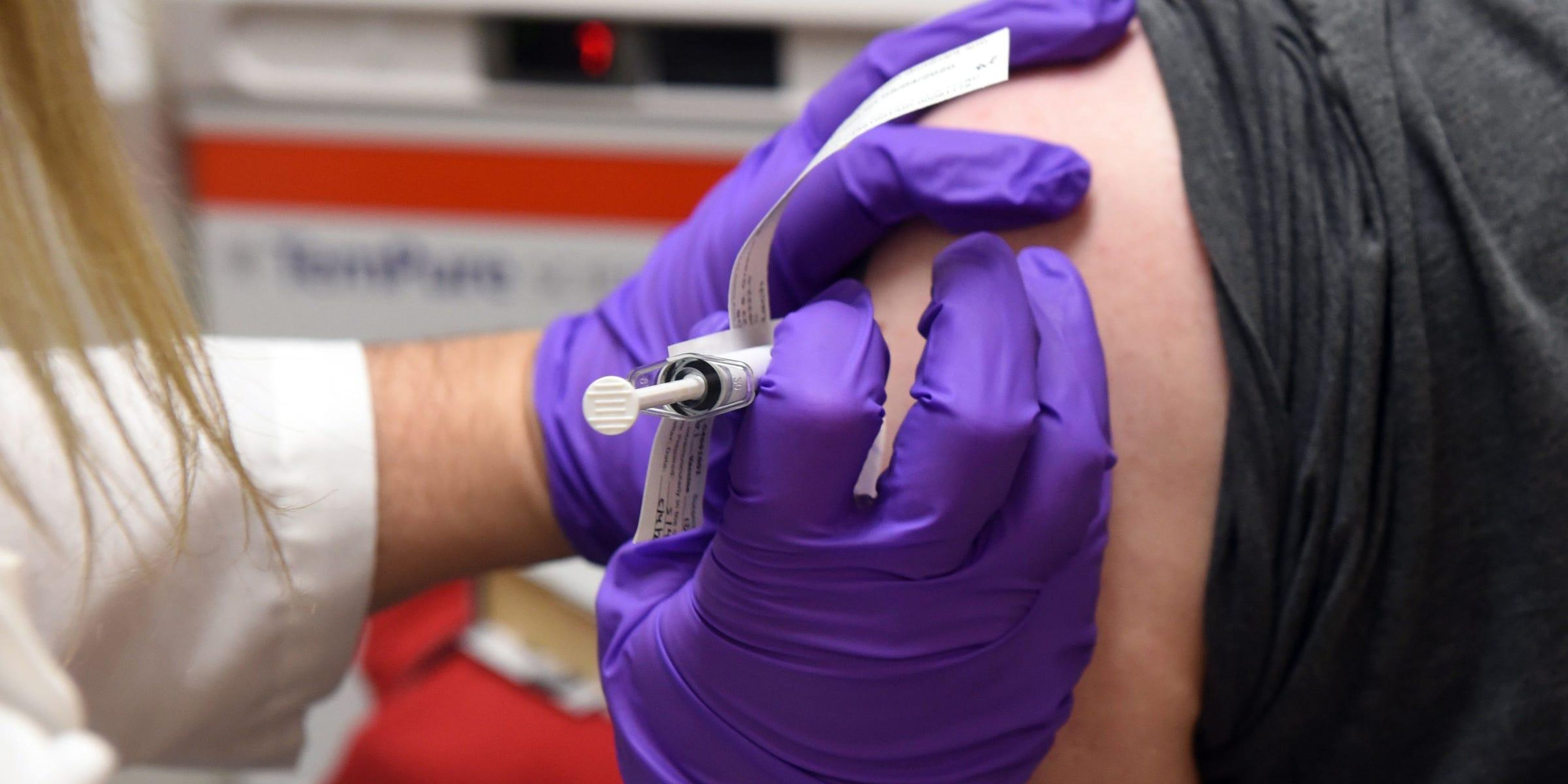 A volunteer receives an experimental coronavirus vaccination in a clinical trial at the University of Maryland's medical school.