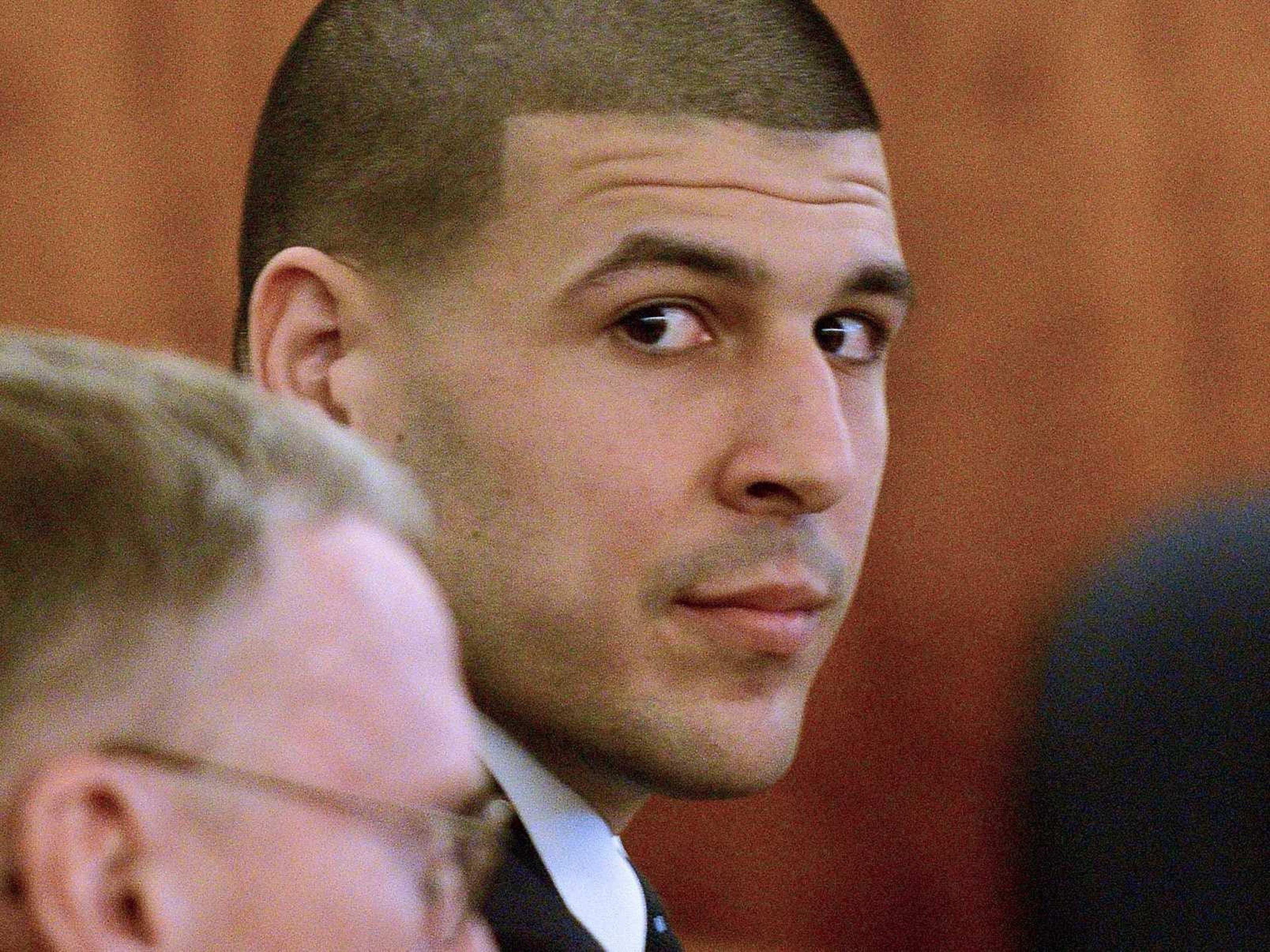 Former New England Patriots football player Aaron Hernandez looks toward the media area during his trial in Fall River, Mass., Monday, April 6, 2015.