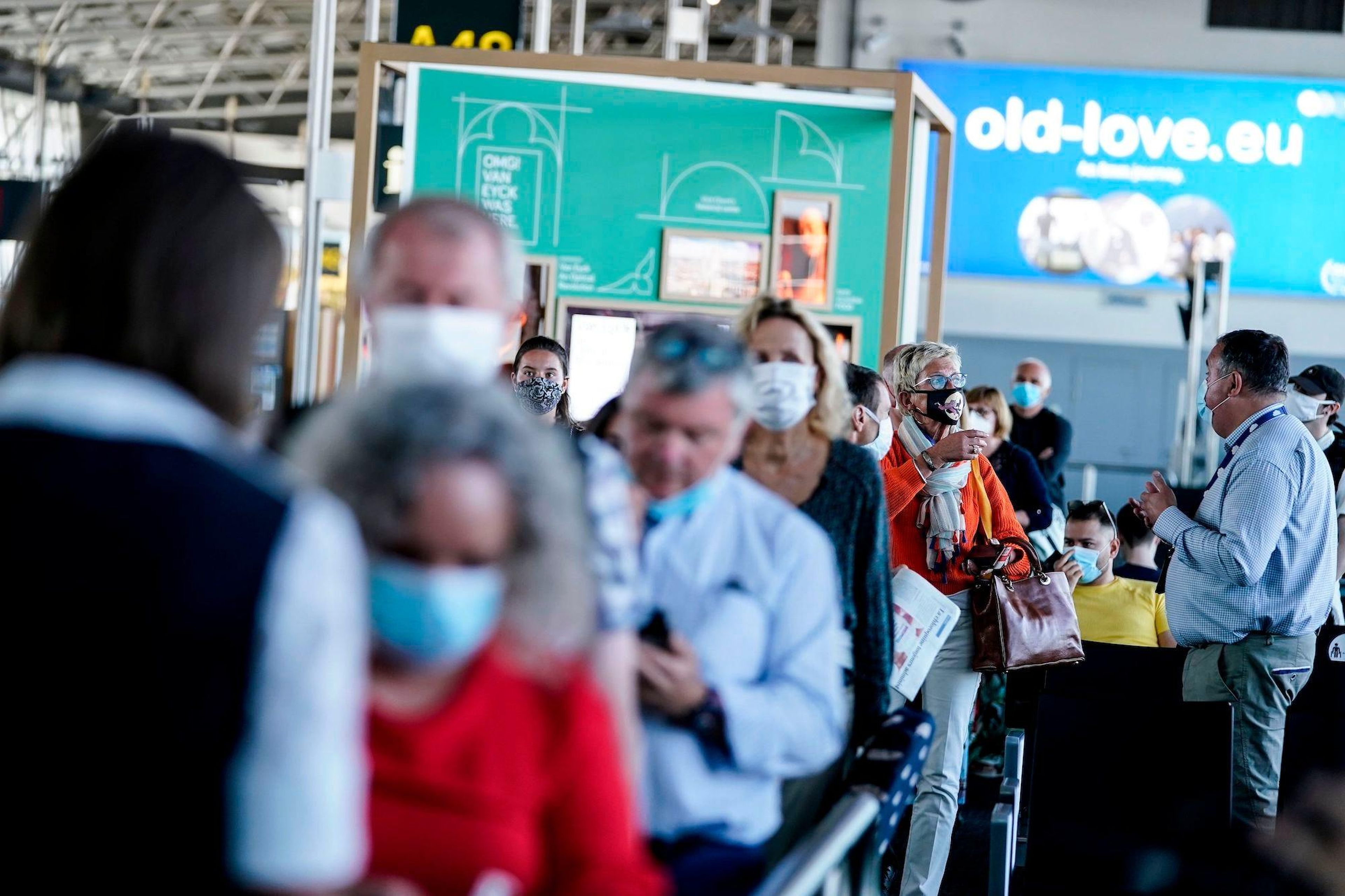 Passengers queue at the boarding gate at Brussels Airport, in Zaventem, on June 15, 2020 as Brussels Airport reopens for travels within Europe and the Schengen zone, after a months-long closure aimed at stemming the spread of the COVID-19 pandemic, caused