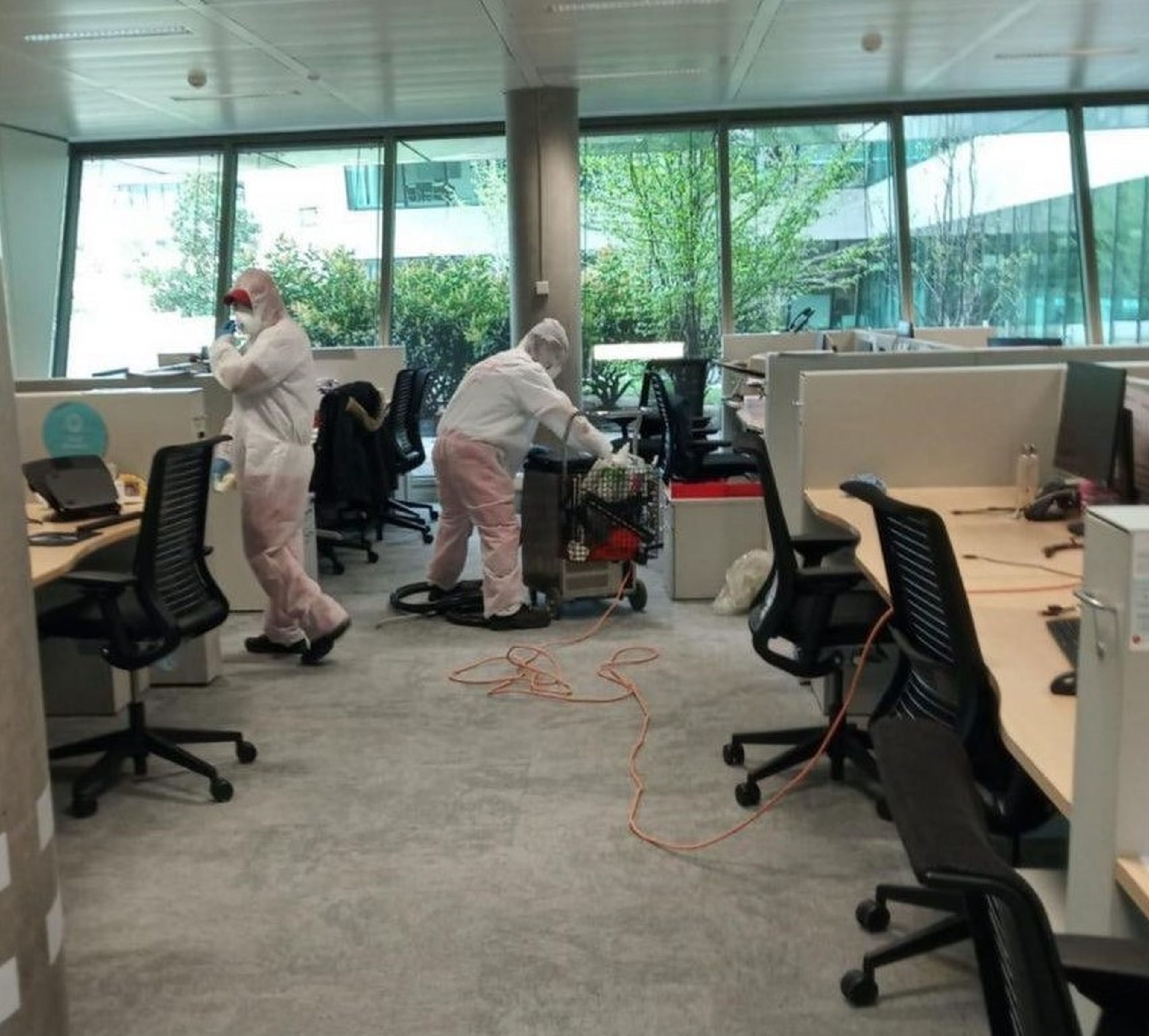 Dos personas limpiando la sede del banco Santander en Boadilla, en Madrid, al inicio de la pandemia.