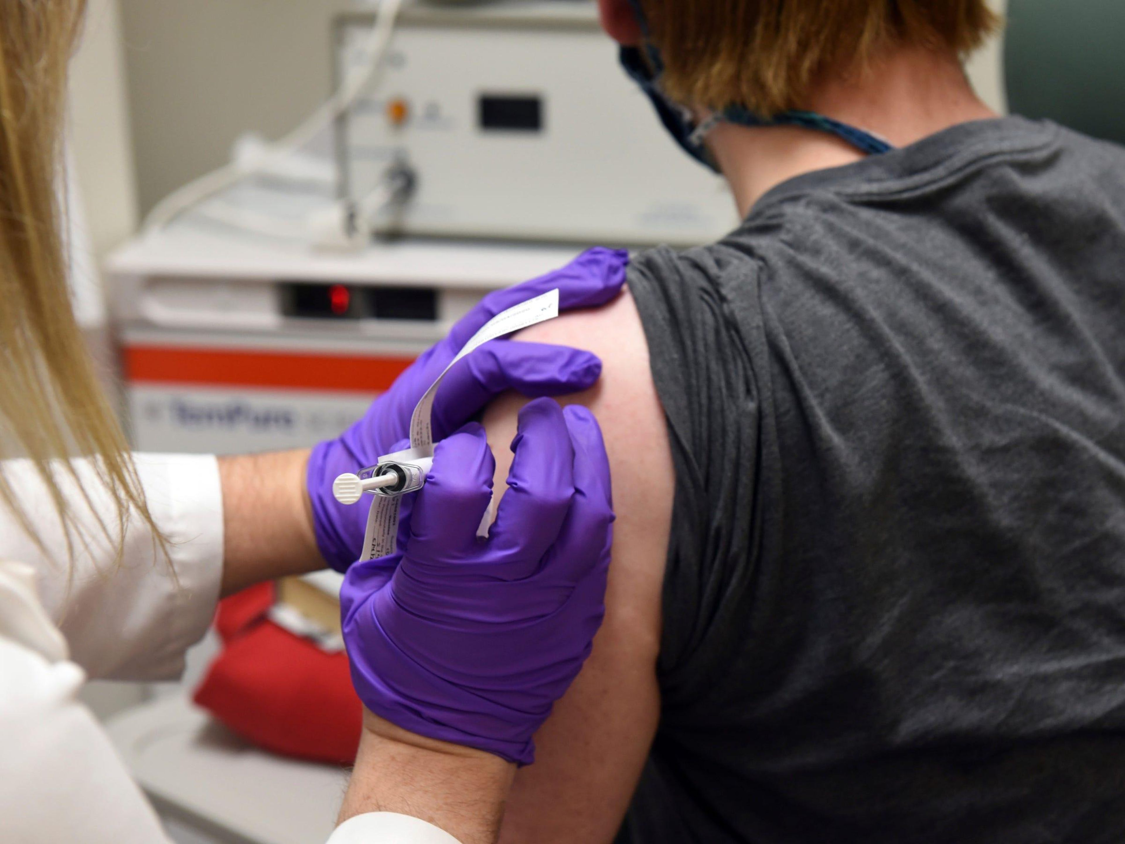 The first patient enrolled in Pfizer's COVID-19 coronavirus vaccine clinical trial receives an injection at the University of Maryland School of Medicine in Baltimore, May 4, 2020.