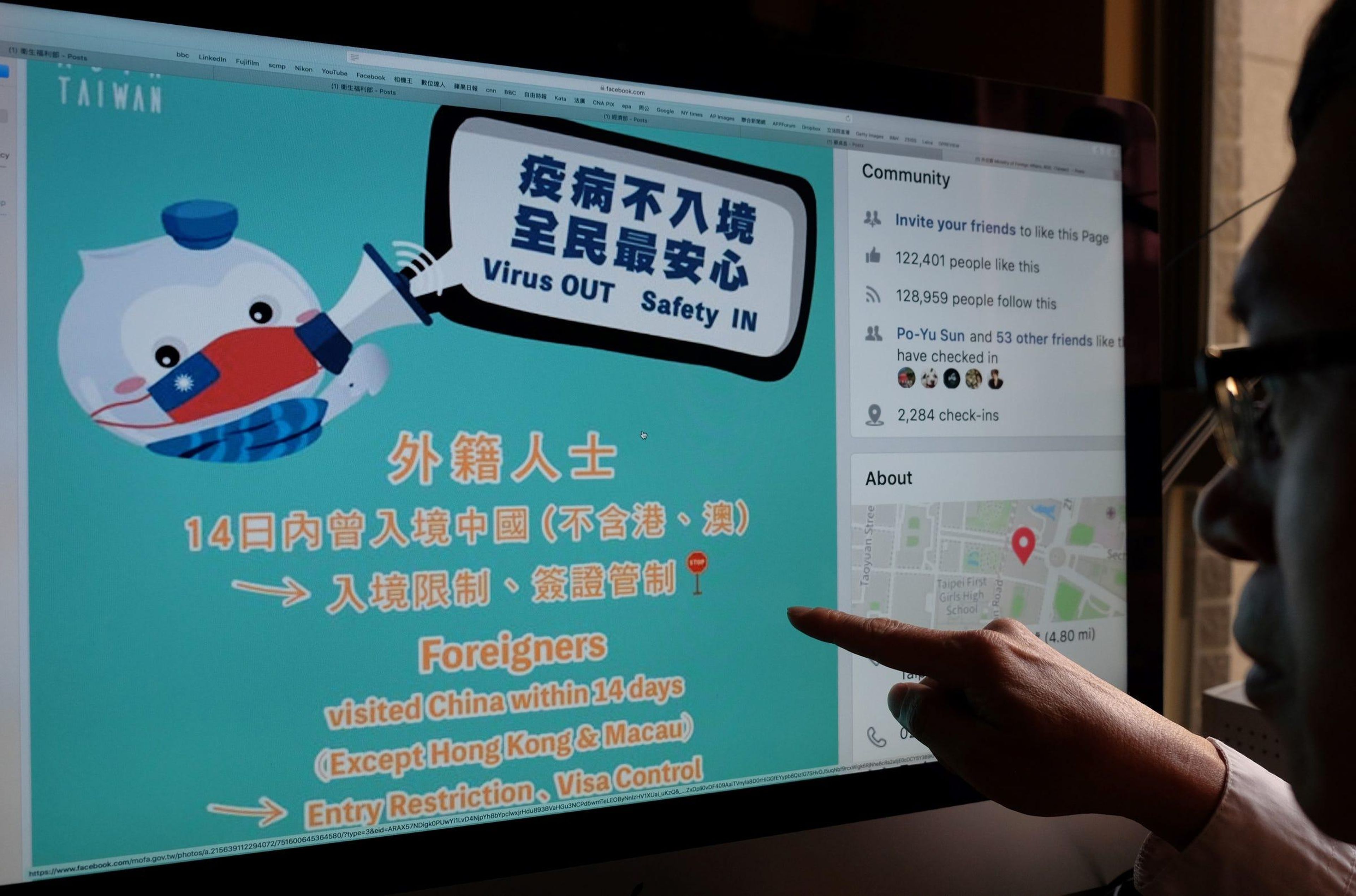 A man points to a webpage from Taiwan's Ministry of Foreign Affairs Facebook account on February 14, 2020.