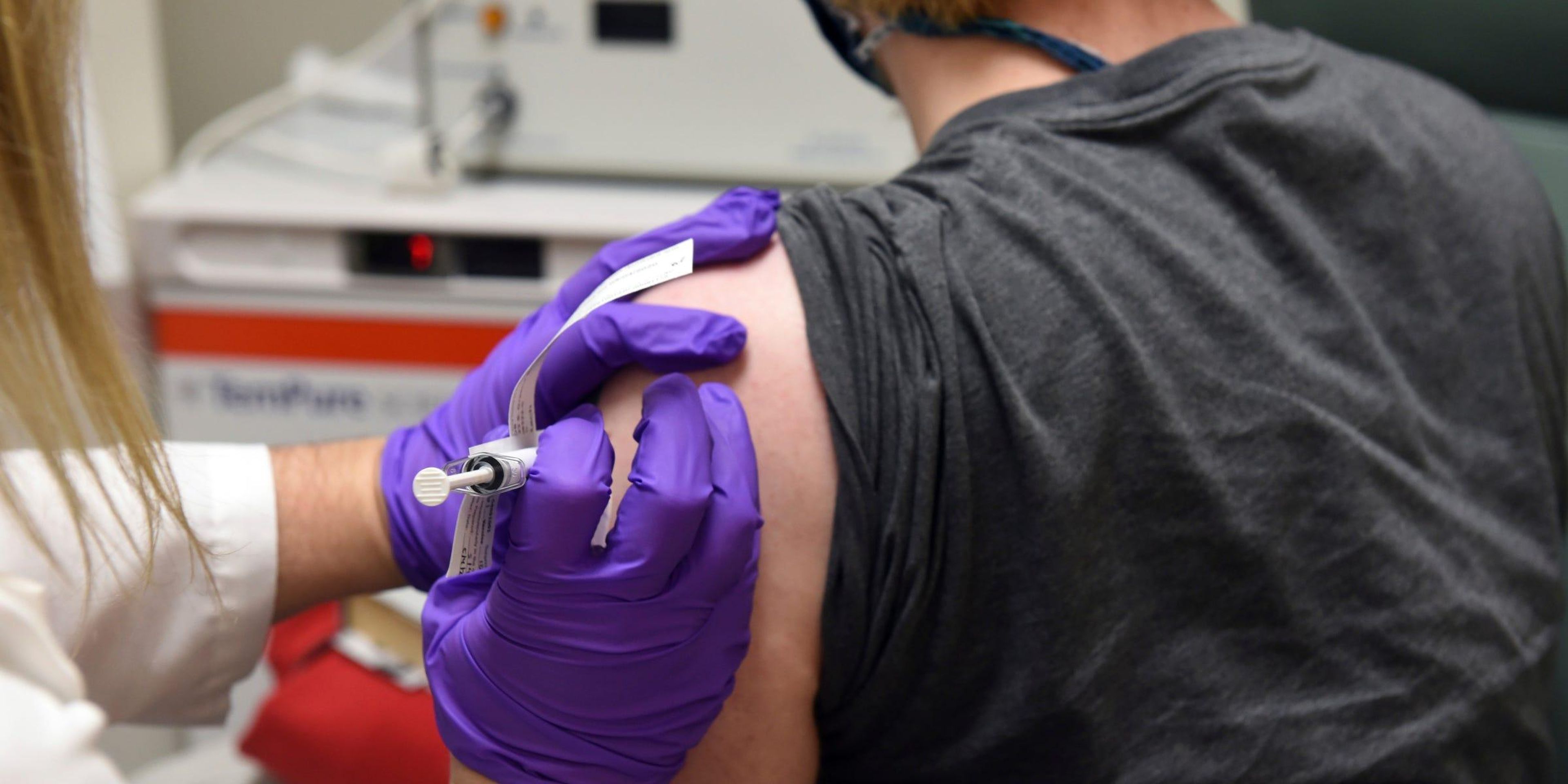 A patient enrolled in a coronavirus vaccine clinical trial receives an injection, May 4, 2020.