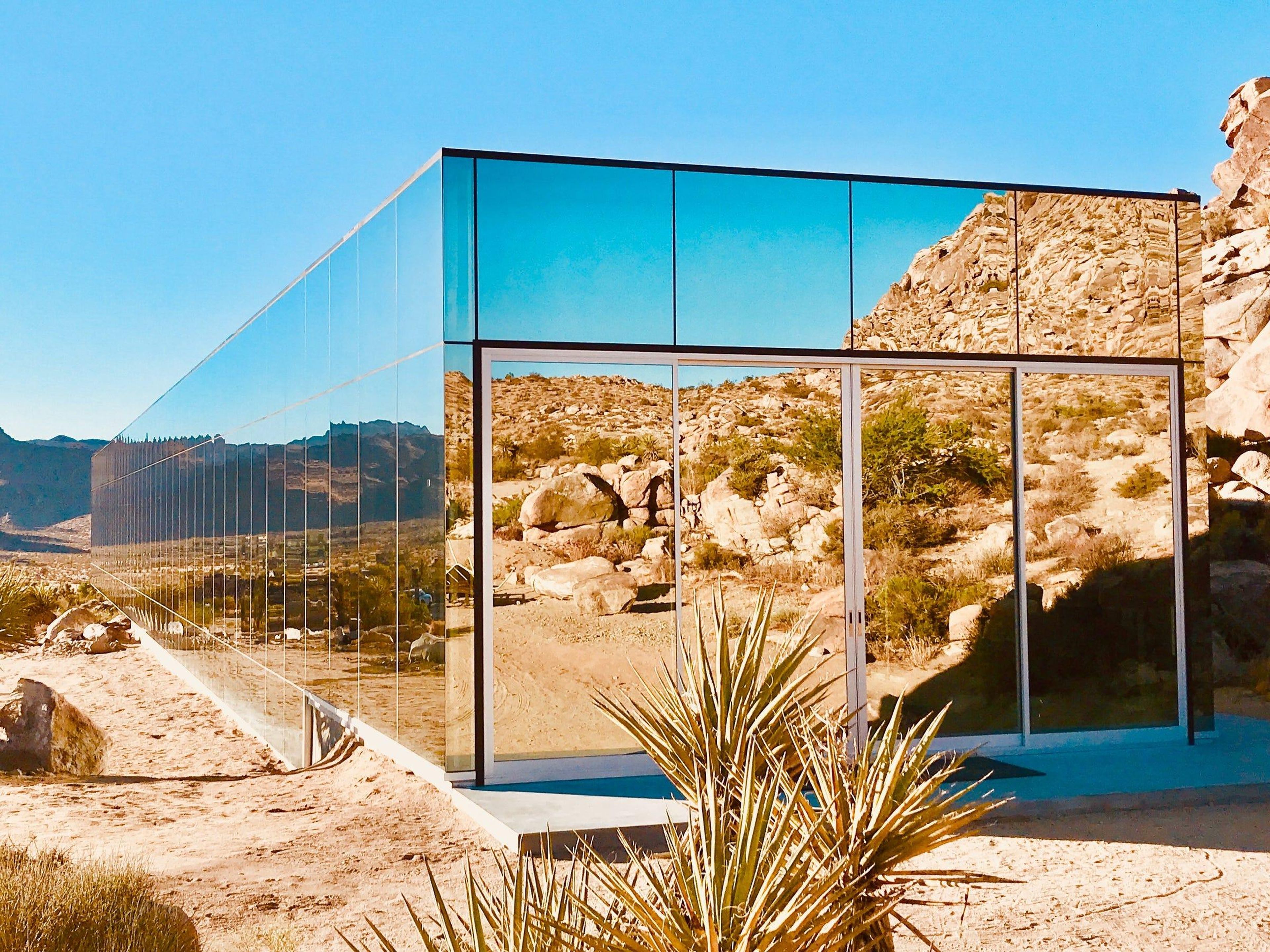 The producer of the cult classic movie 'American Psycho' designed a home in Joshua Tree that looks like a fallen skyscraper, and it's almost entirely covered in mirrors. Take a look inside.
