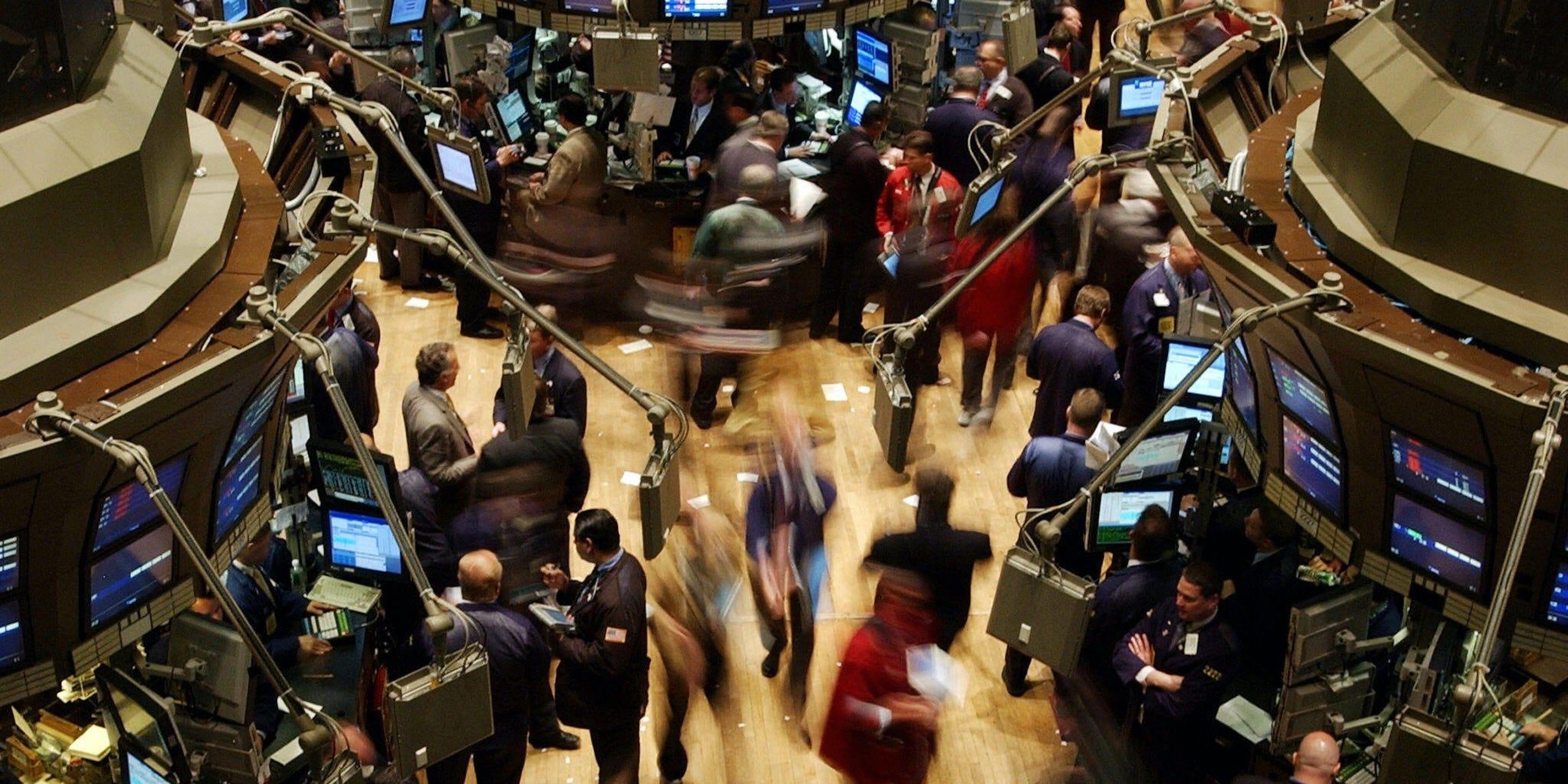 Traders working on the floor of the New York Stock Exchange are blur in this time exposure, just before the opening bell, 11 May, 2004.