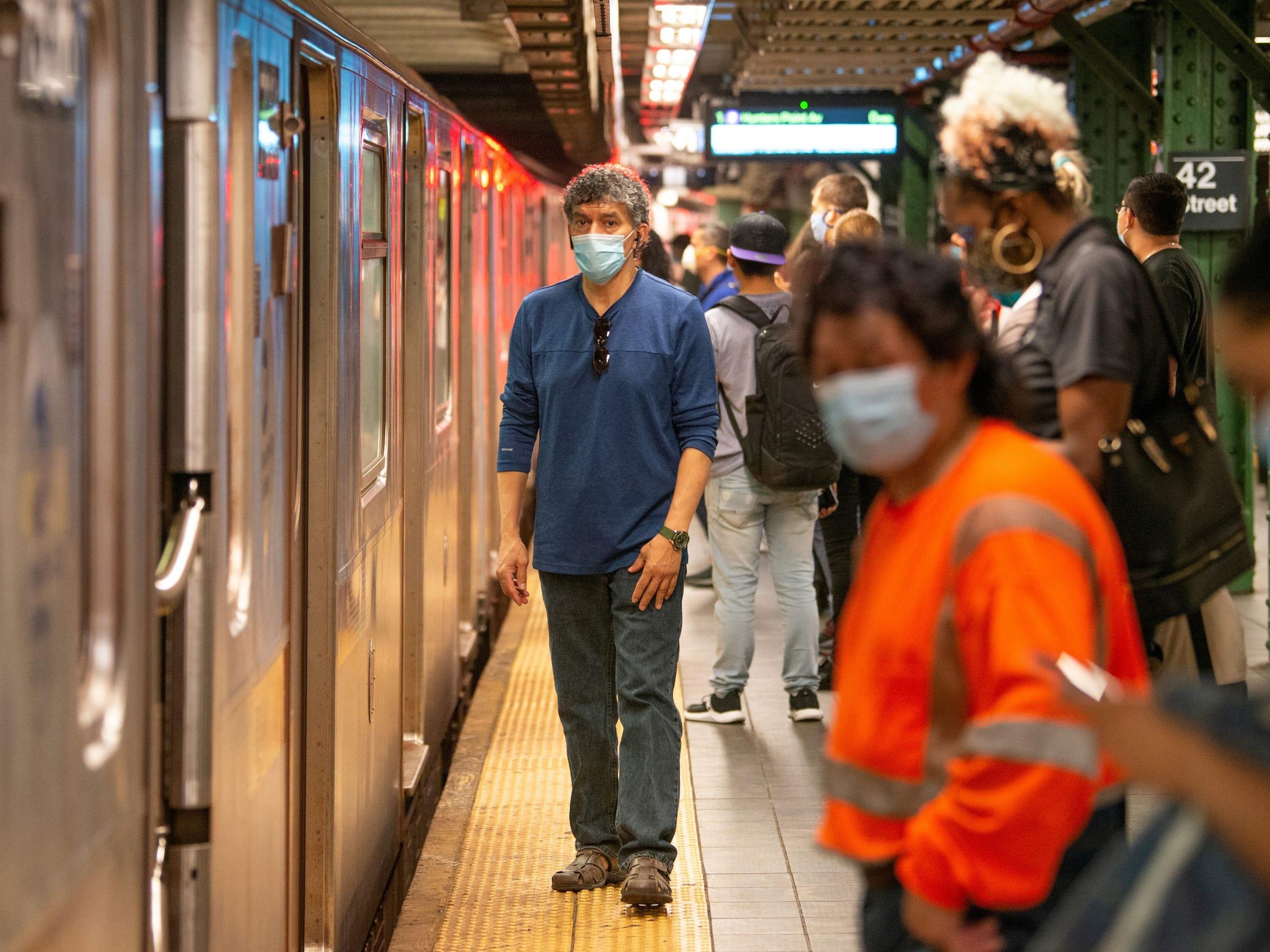 People wearing masks wait on a crowded subway platform on May 30, 2020, in New York City. Alexi Rosenfeld/Getty Images