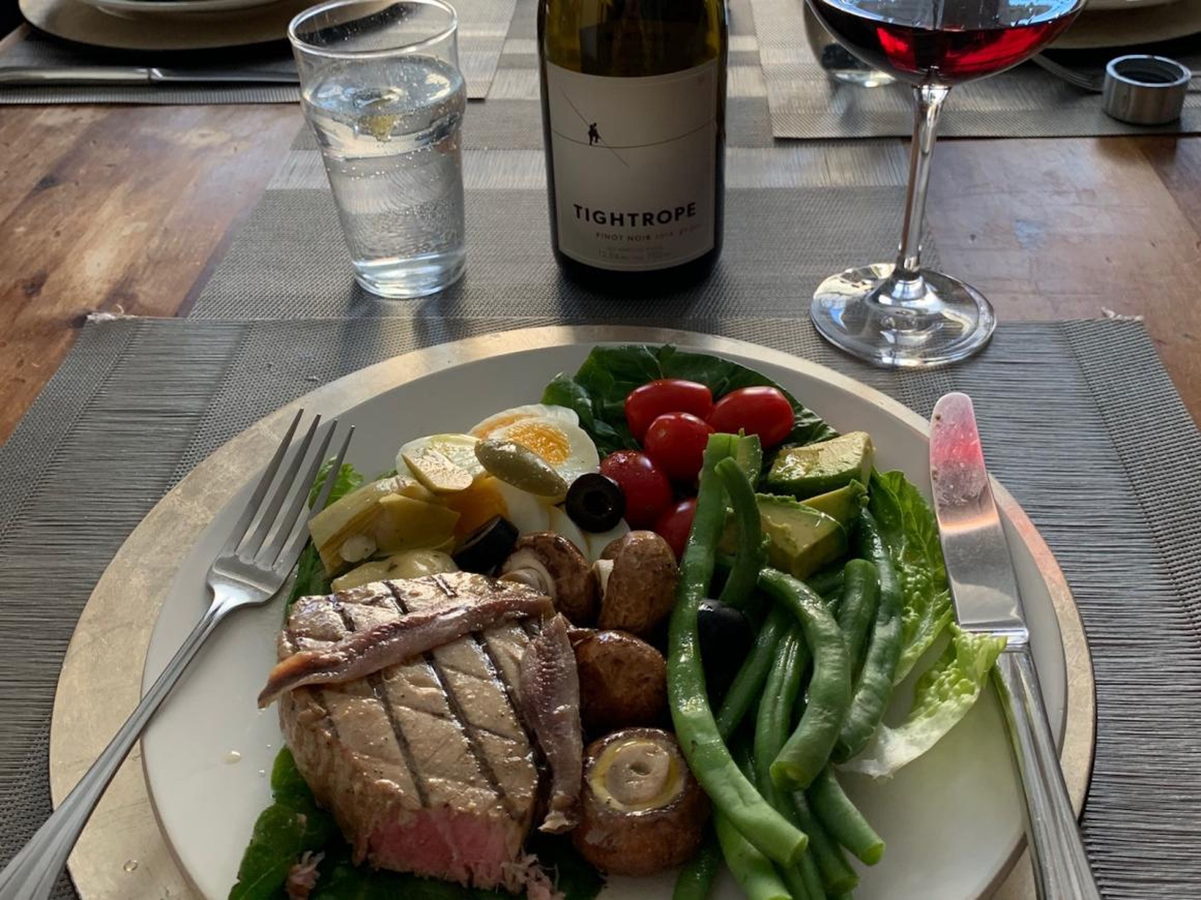 A standard dinner at David Harper's house: a tuna nicoise salad (hold the potatoes) served with a glass of red wine.