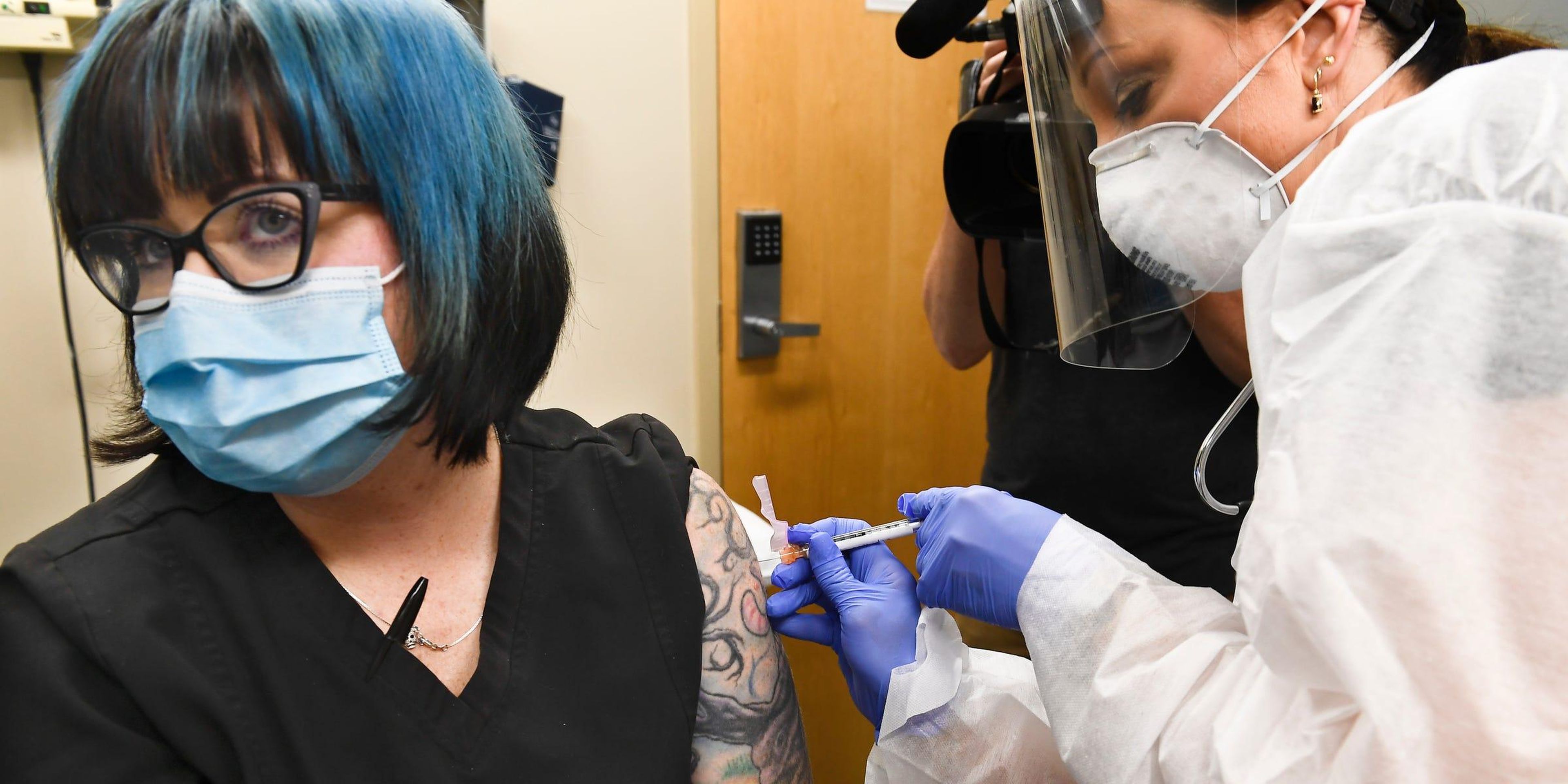 A volunteer is injected with a trial vaccine from Moderna Inc. in Binghamton, New York, on July 27, 2020. AP Photo/Hans Pennink