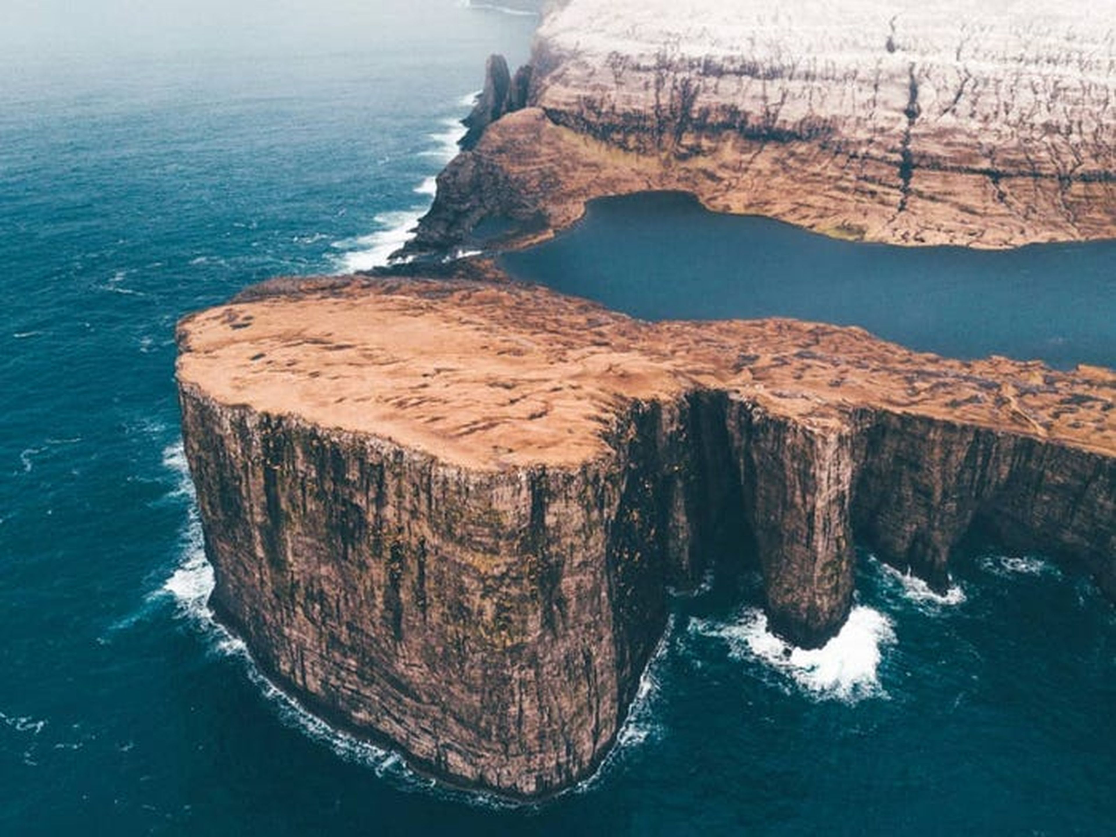 Algunas imágenes parecen surrealistas, como esta de las Islas Feroe, donde se ve un lago en lo alto de un acantilado.