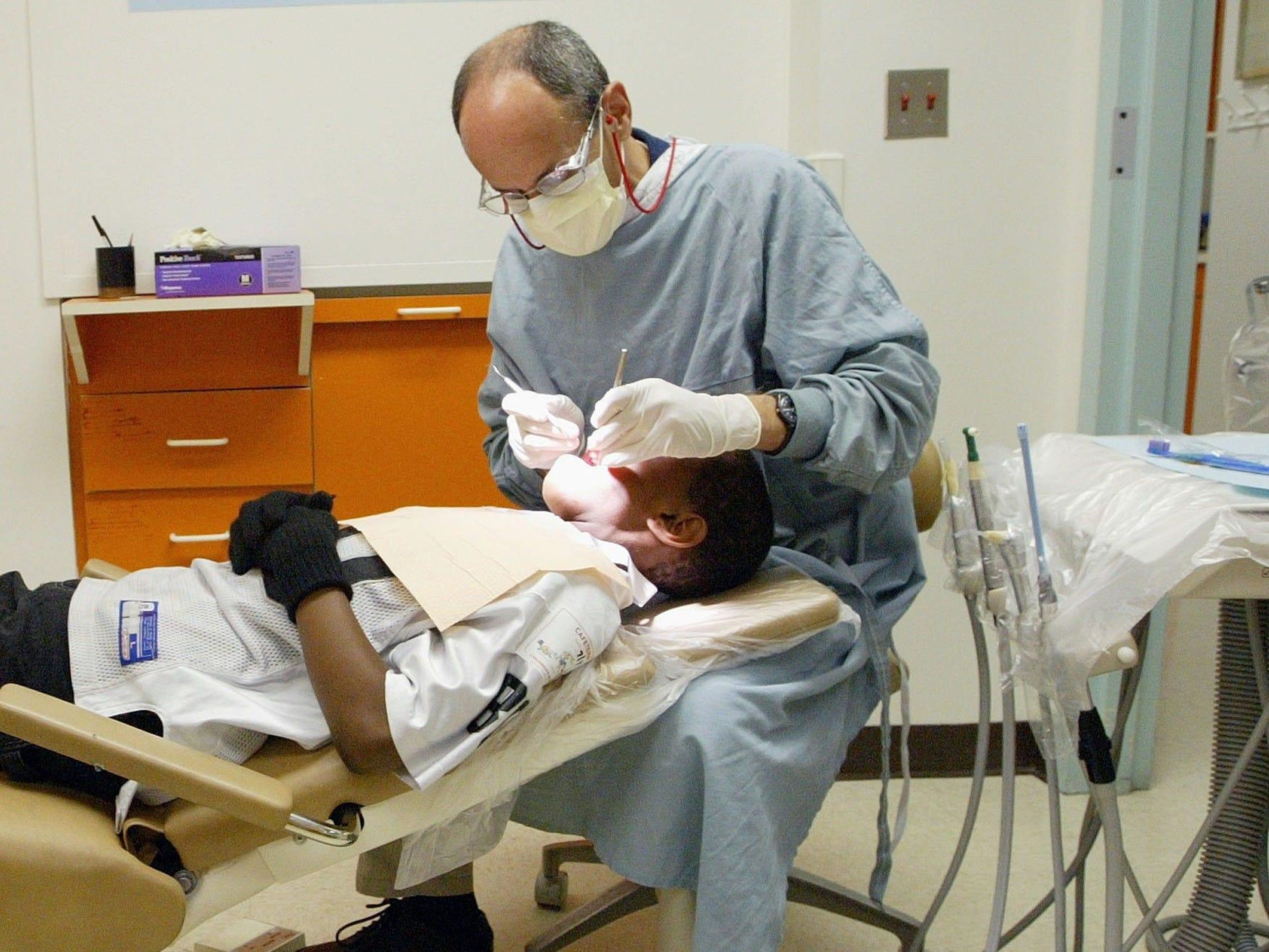 A dentist performs a dental examination. Justin Sullivan/Getty Images