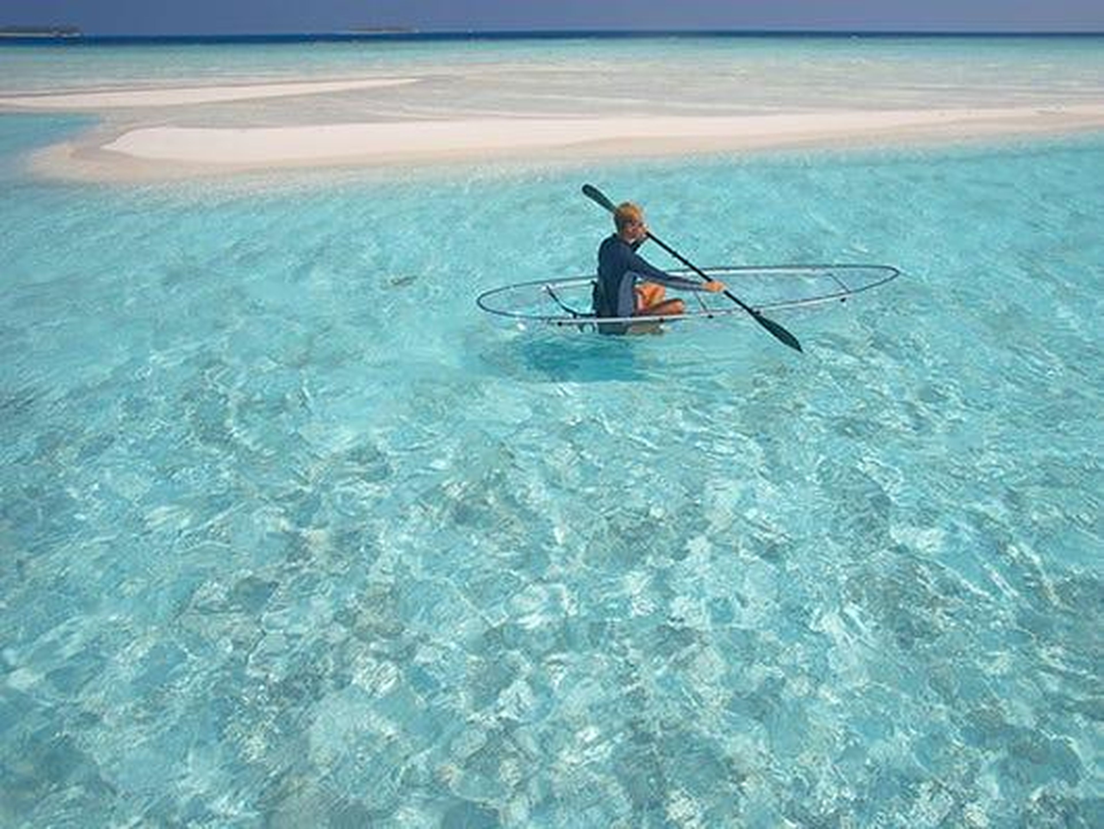 Guests can go diving and paddling the clear blue waters in a translucent canoe.