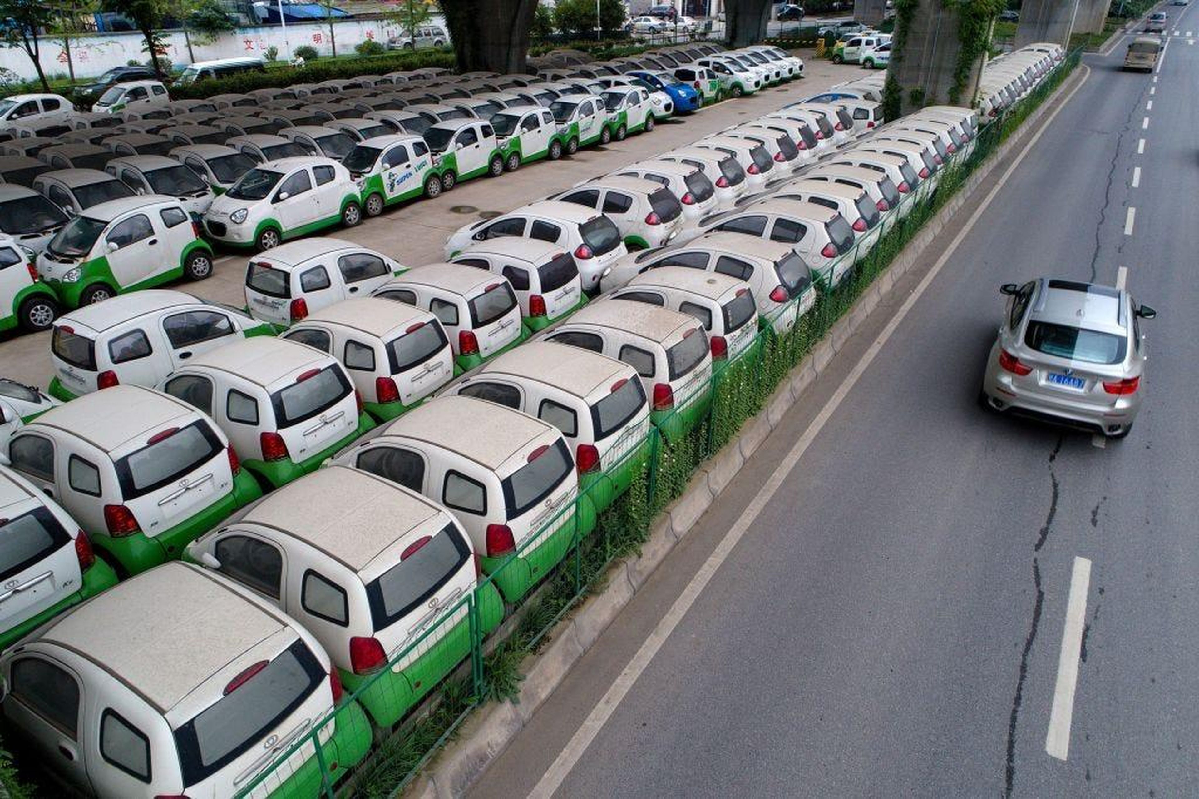 New electric vehicles parked in a parking lot under a viaduct in Wuhan, central China's Hubei province. STR/AFP/Getty Images