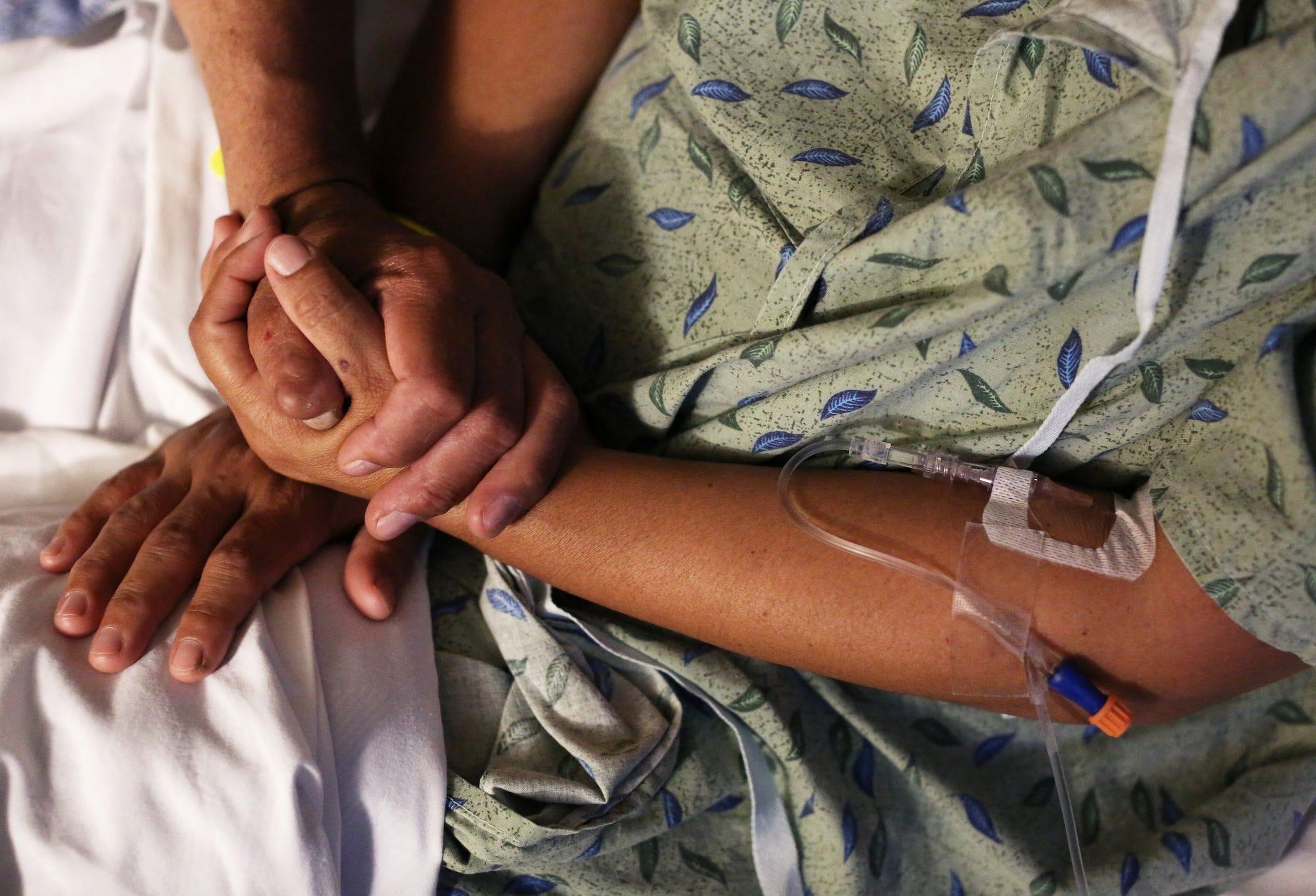 A patient is comforted by her husband at St. Joseph's Hospital in Tucson, Arizona. Caitlin O'Hara/Reuters