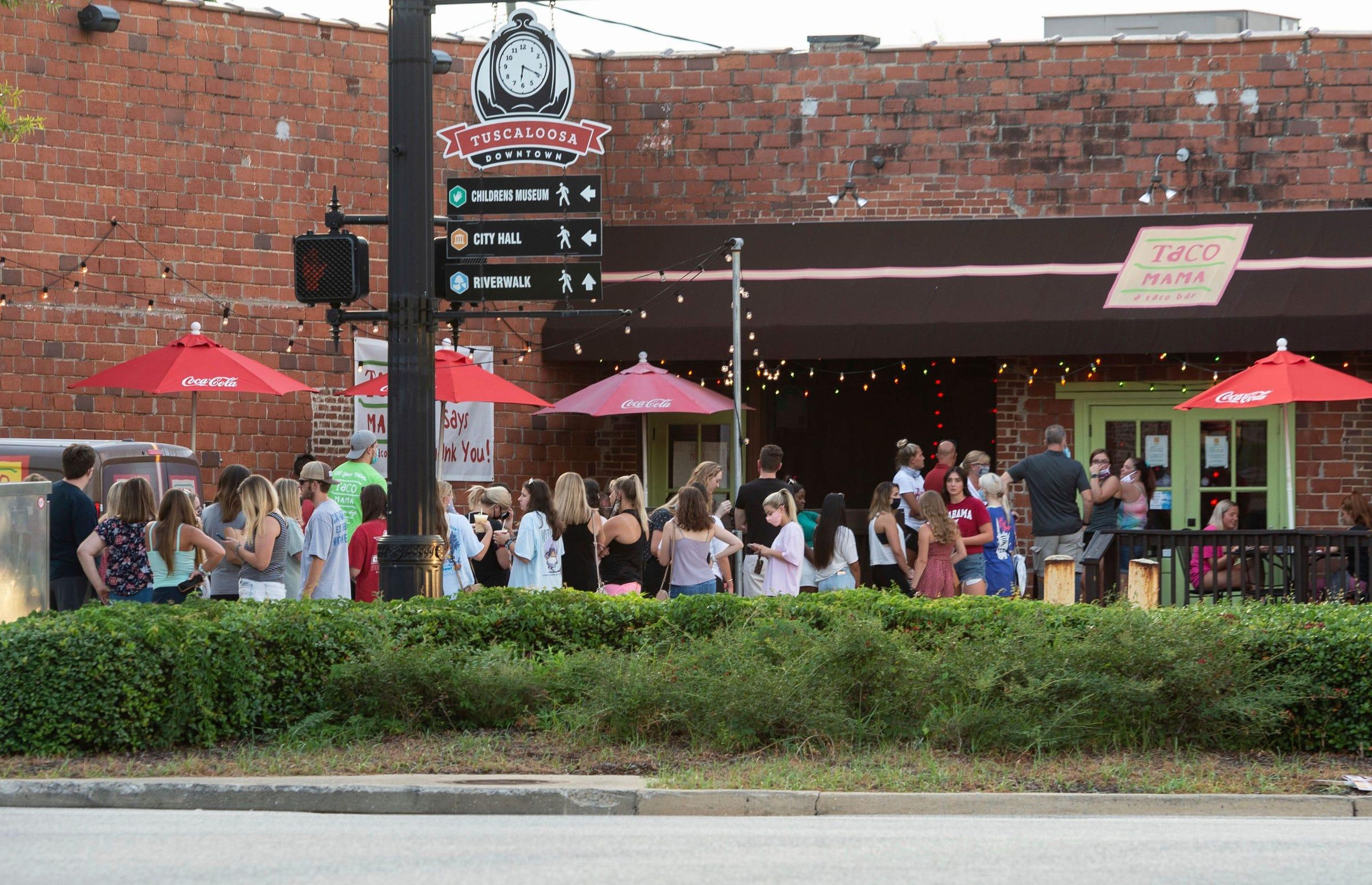 People line up outside to wait for limited access indoors to order food from Taco Mama in Tuscaloosa, Alabama, on August 15, 2020. AP Photo/Vasha Hunt