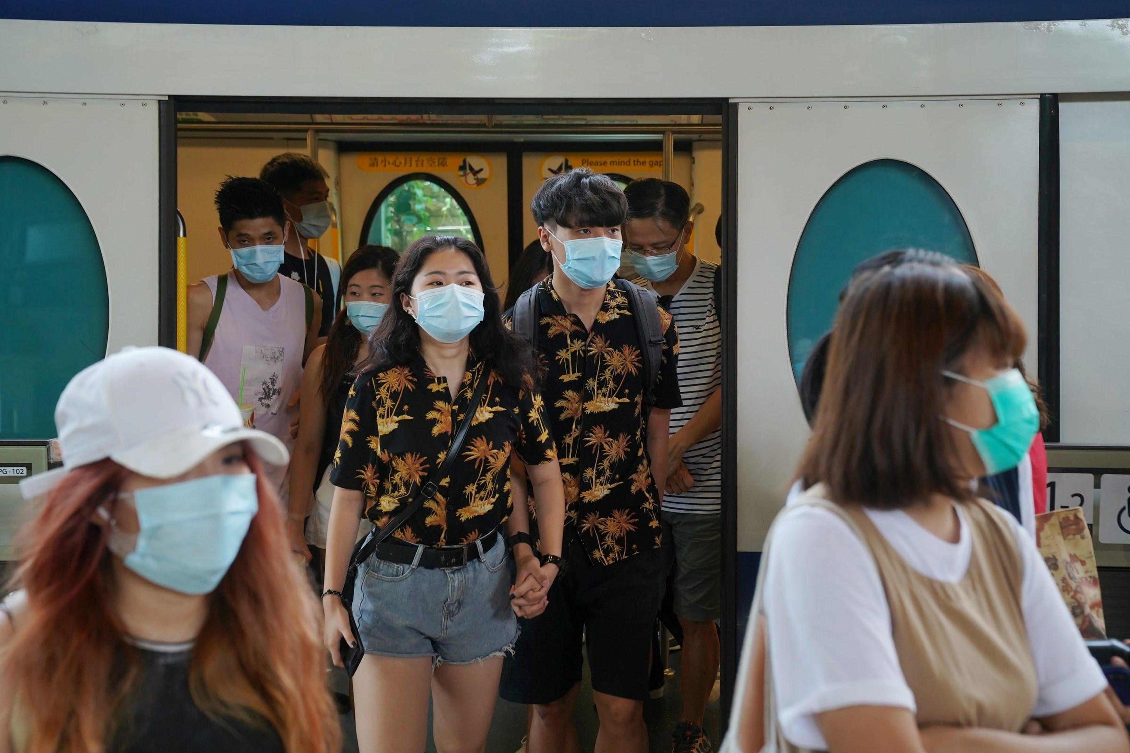 People walk out of a train at a subway station near the Hong Kong Disneyland Resort in Hong Kong, July 14, 2020. Lam Yik/Reuters