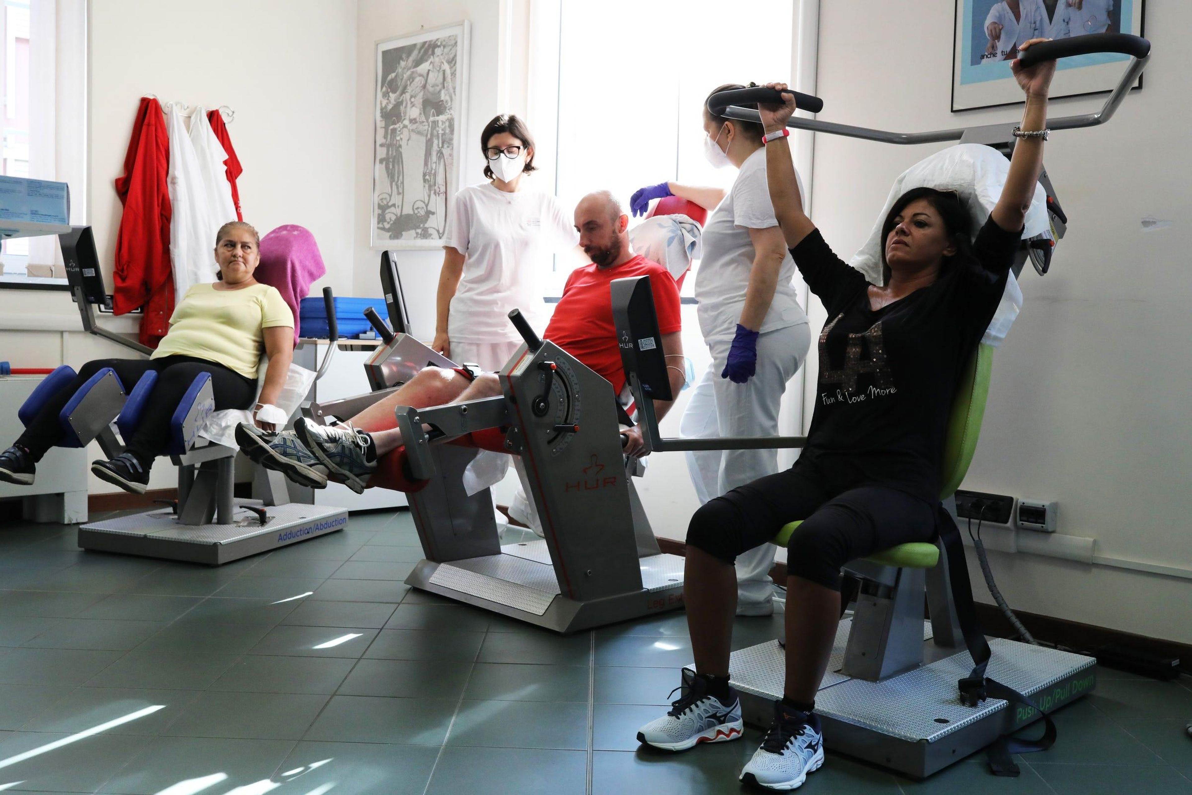 Recovering coronavirus patients train on a machine to strengthen muscle tone at the Department of Rehabilitative Cardiology in Genoa, Italy, on July 22, 2020. Marco Di Lauro/Getty Images